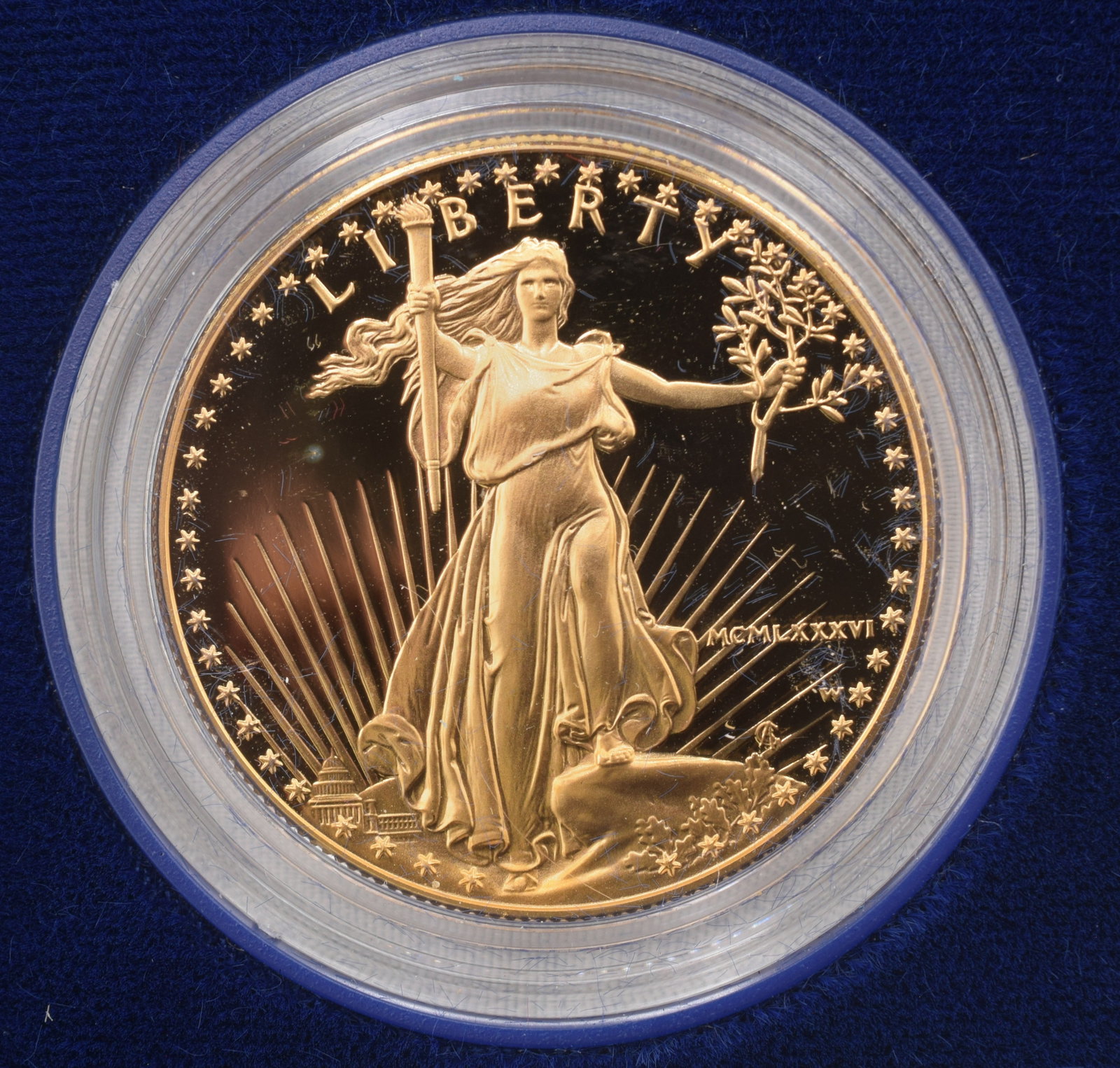 1986 ONE OUNCE FIFTY DOLLAR GOLD COIN: Minted at West Point Bullion Depository. American Eagle gold bullion coin comes in blue case with certificate of authenticity. Coin is 1 ounce fine gold, mint mark "W" Good condition. 1.28"Diameter.