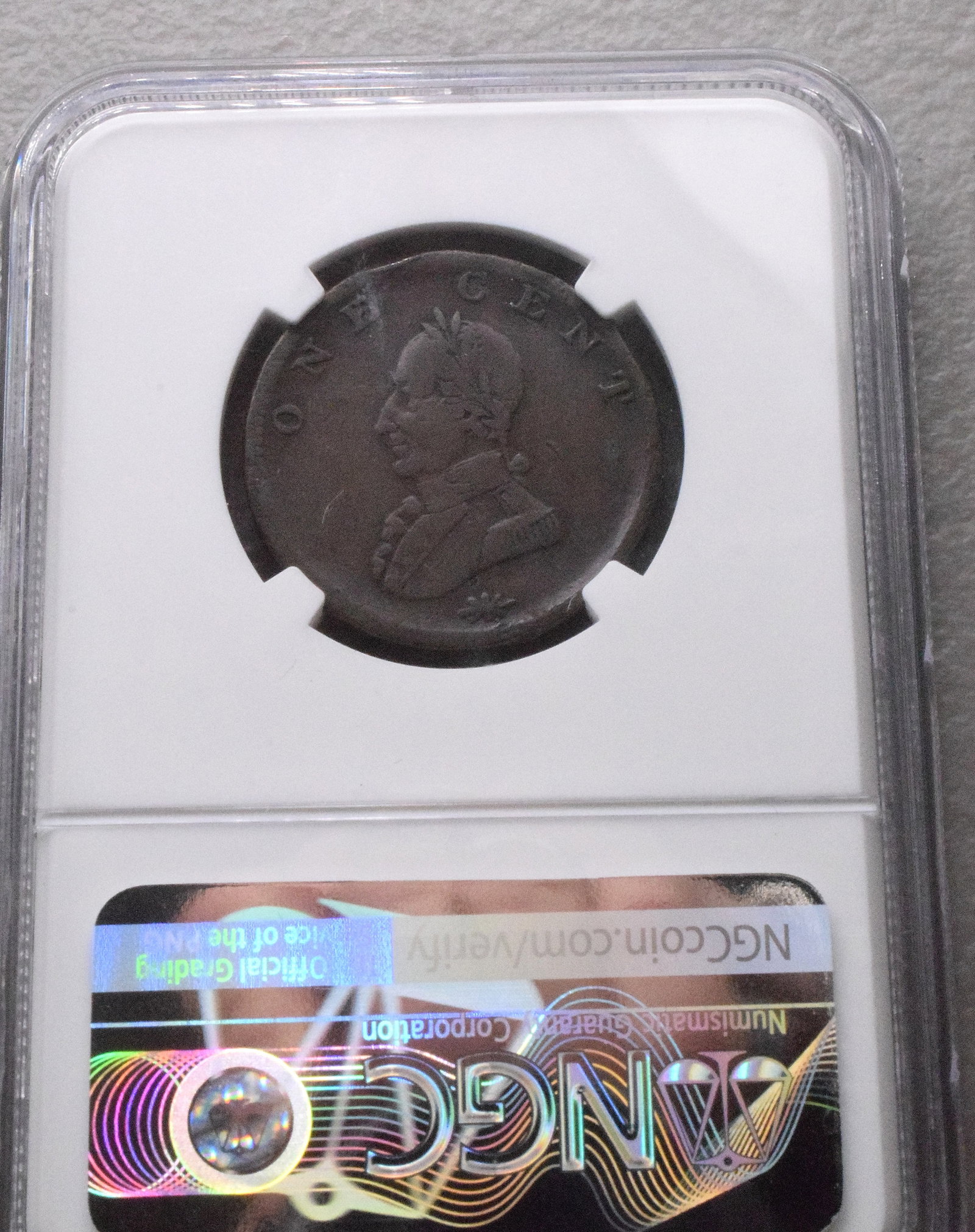 UNDATED COPPER WASHINGTON 1 CENT: US Washington 1 cent copper coin, undated, double headed military bust. Graded, has environmental damage. NGC condition.1 inch diameter. White's Auctions will not take credit cards on goldjewelry,