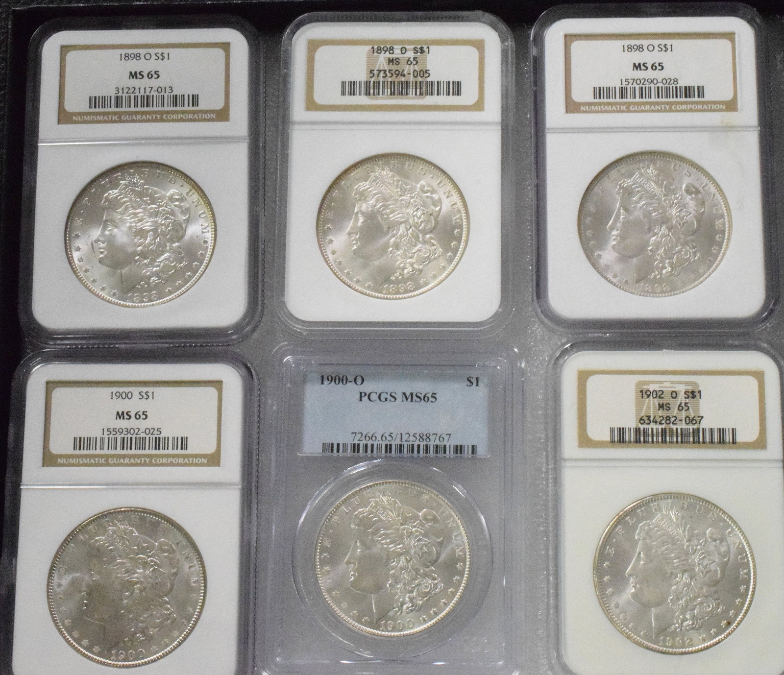 7 GRADED US MORGAN SILVER DOLLARS, VARIOUS DATES - 2