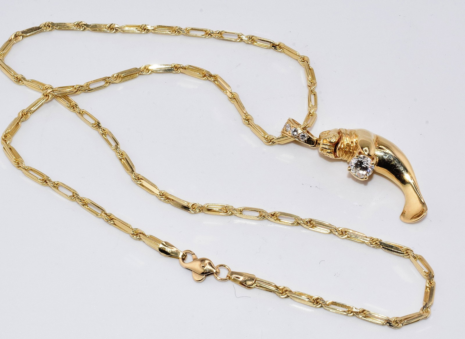 14K DIAMOND MANATEE PENDANT WITH 14K LINK CHAIN: Vintage 14k Manatee pendant with a white round diamond and 4 graduates white diamond bail. Pendant approx.1 3/4 inch long. Approx. 10.2 DWT. Main diamond approx. 3/4 carat. The graduateddiamond