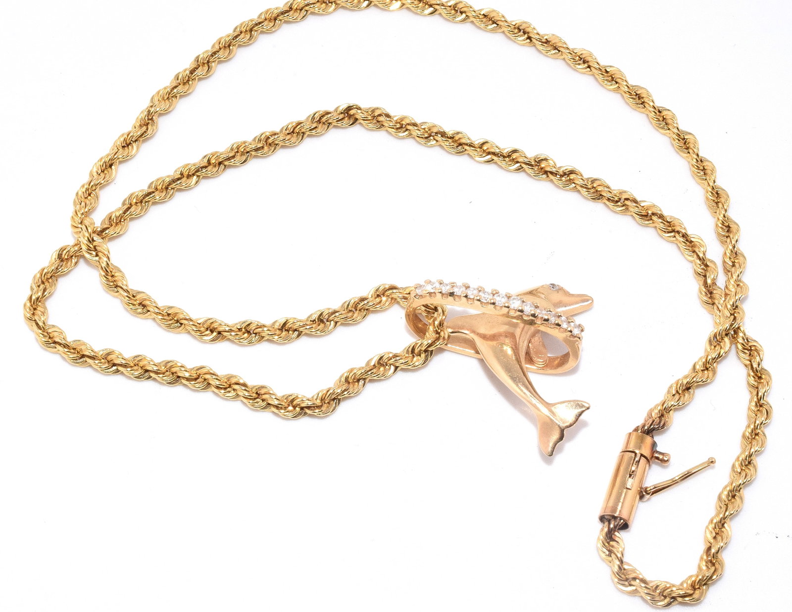 14K DOLPHIN PENDANT WITH DIAMONDS & 14K NECKLACE: Vintage 14k figural dolphin pandent with diamond eye and diamond set bail. Figural dolphin jumping though a loop. Approx. 1 inch x 1 inch. Pendant approx. 3 DWT. Rope style necklace approx. 17inches.