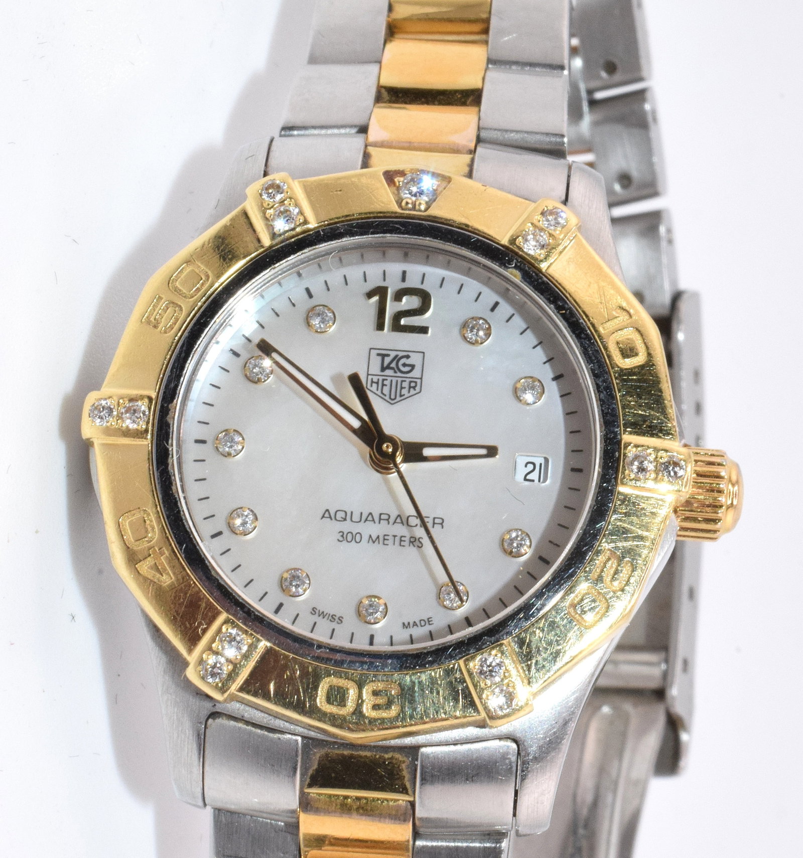 TAG HEUER AQUARACER LADY'S WRIST WATCH: Vintage Tag Heuer Aquaracer lady's WAF1451.BB0814 Quartz pearl diamond 18k gold wrist watch. Face marked Tag Heuer automatic 300 meters Swiss made. Back marked Stainless steel & 18k, FC5477,