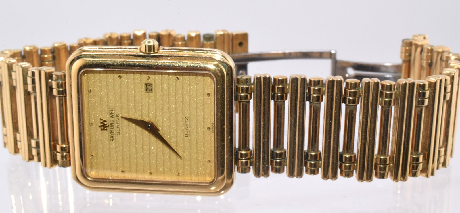 RAYMOND WEIL WRIST WATCH: Vintage Raymond Weil Geneva Switzerland tank style "9983" model wrist watch. 18k electroplated 10M. Gold tone face. Band and watch all marked. Quartz movement. Needs battery. Good condition. Believewo