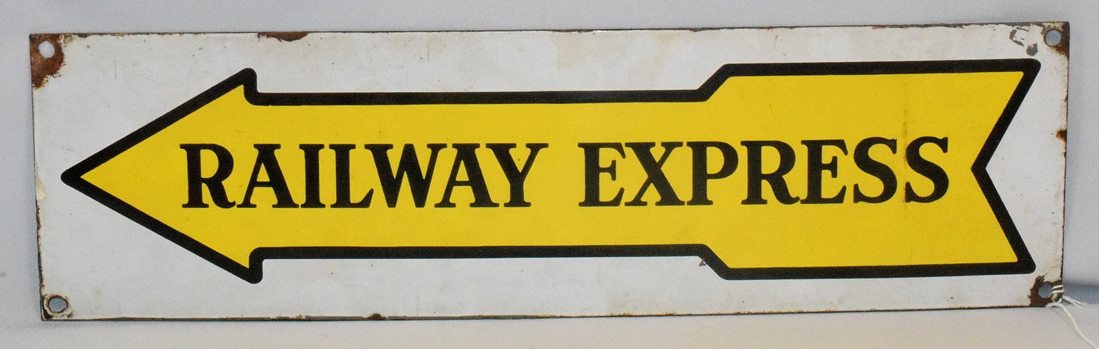 RAILWAY EXPRESS SINGLE SIDED PROCELAIN ARROW SIGN: Railway Express Single Sided Porcelain Arrow Sign, single sided porcelain sign on steel with black outlined yellow enamel arrow, black enamel Railway Express inside, and white enamel. Measures 23 " x