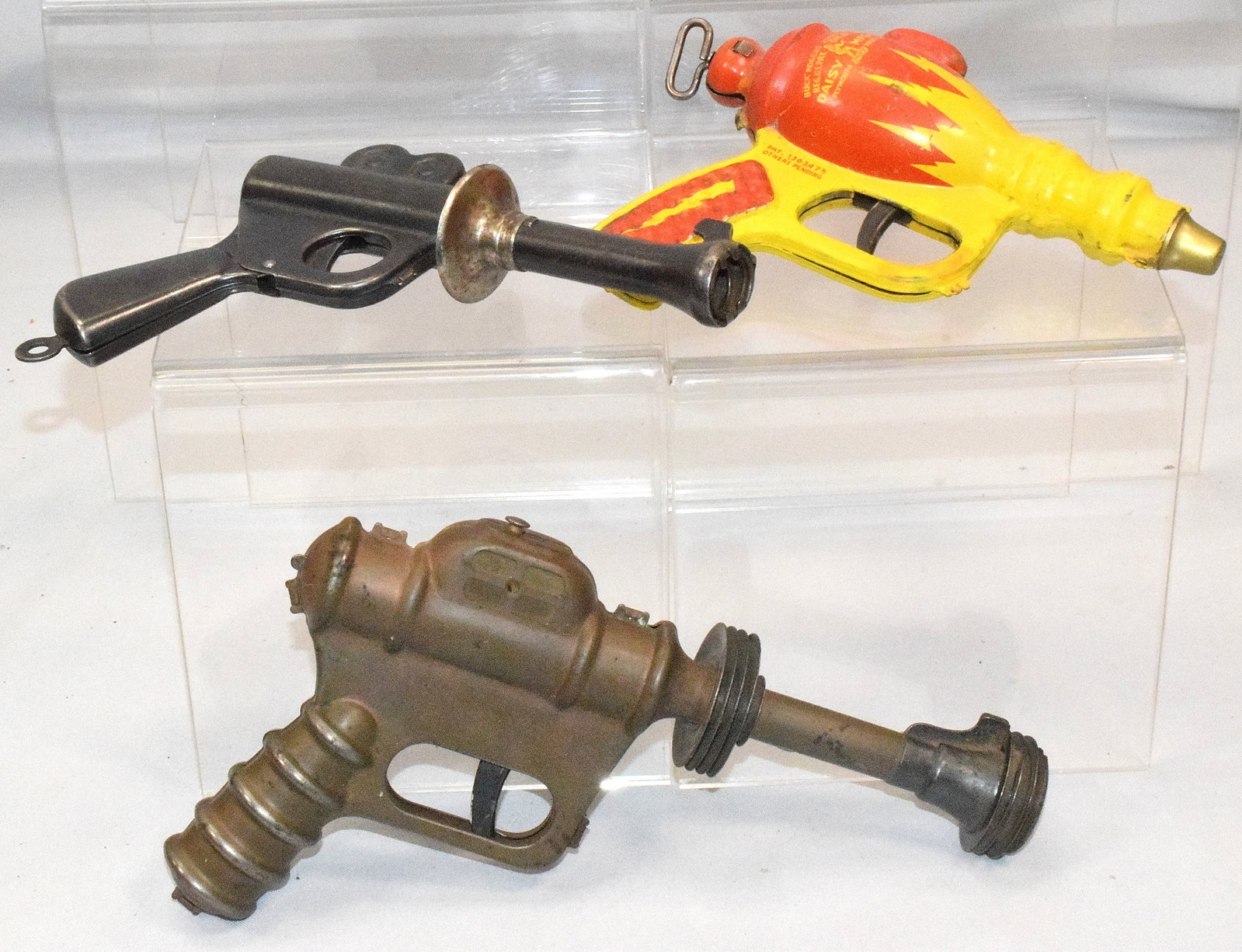 3 ASSORTED BUCK ROGERS RAY GUNS: 1) Buck Rogers Tin Space Gun, 25th Century Liquid Helium Water Pistol Daisy MFG Co. Great quality and detail and beautiful colors, 7 1/2 " x 6 ", one pound. 2) 1930s Daisy Buck Rogers '