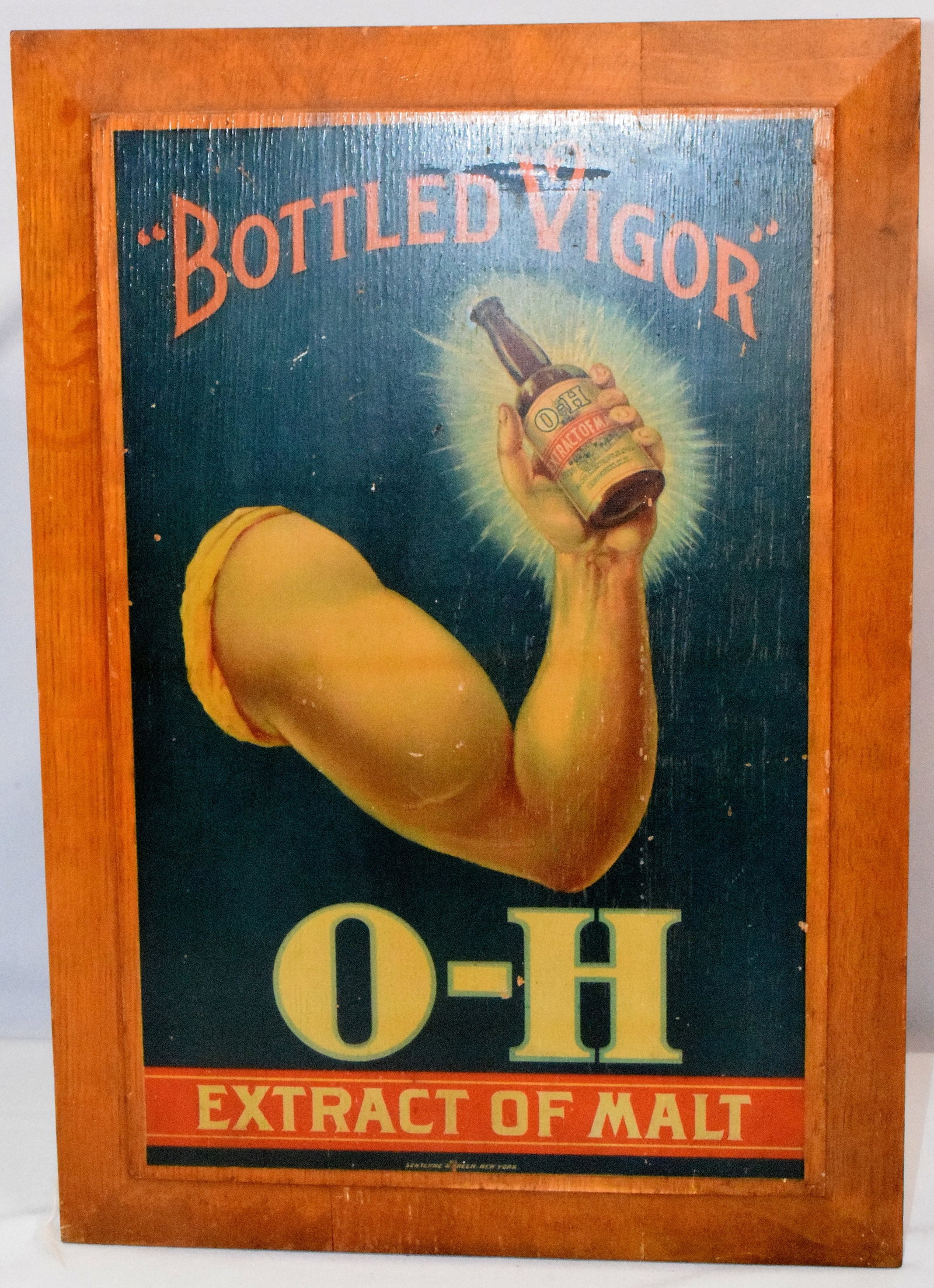 MALT EXTRACT "BOTTLED VIGOR" WOODEN SIGN: Early wood Painted sign from Otto Huber Brewery. Blue background, features arm holding extract of malt bottle with "Bottled Vigor" printed in red at top. Bottom is signed by Sentenne & Green company