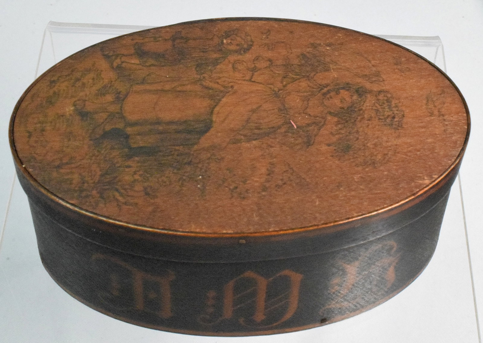 BLACK OVAL PAINTED SHAKER BOX WITH SCETCH ON LID: 3 fingered oval black painted shaker box with copper nails and a sketch of mother and son on the lid, and on the inside of the lid it says " this set lacks a red bishop ". It measures 2 " x 5 1/2",