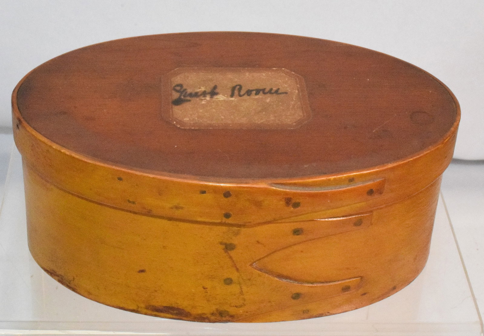 SHAKER 3 FINGERED OVAL GUEST ROOM BOX: 3 fingered oval guest room lidded box with copper nails, it measures 2 1/2 " x 5 1/2 ", has natural finish on top and bottom on the box but on the middle section it's repainted more to a spicymustard