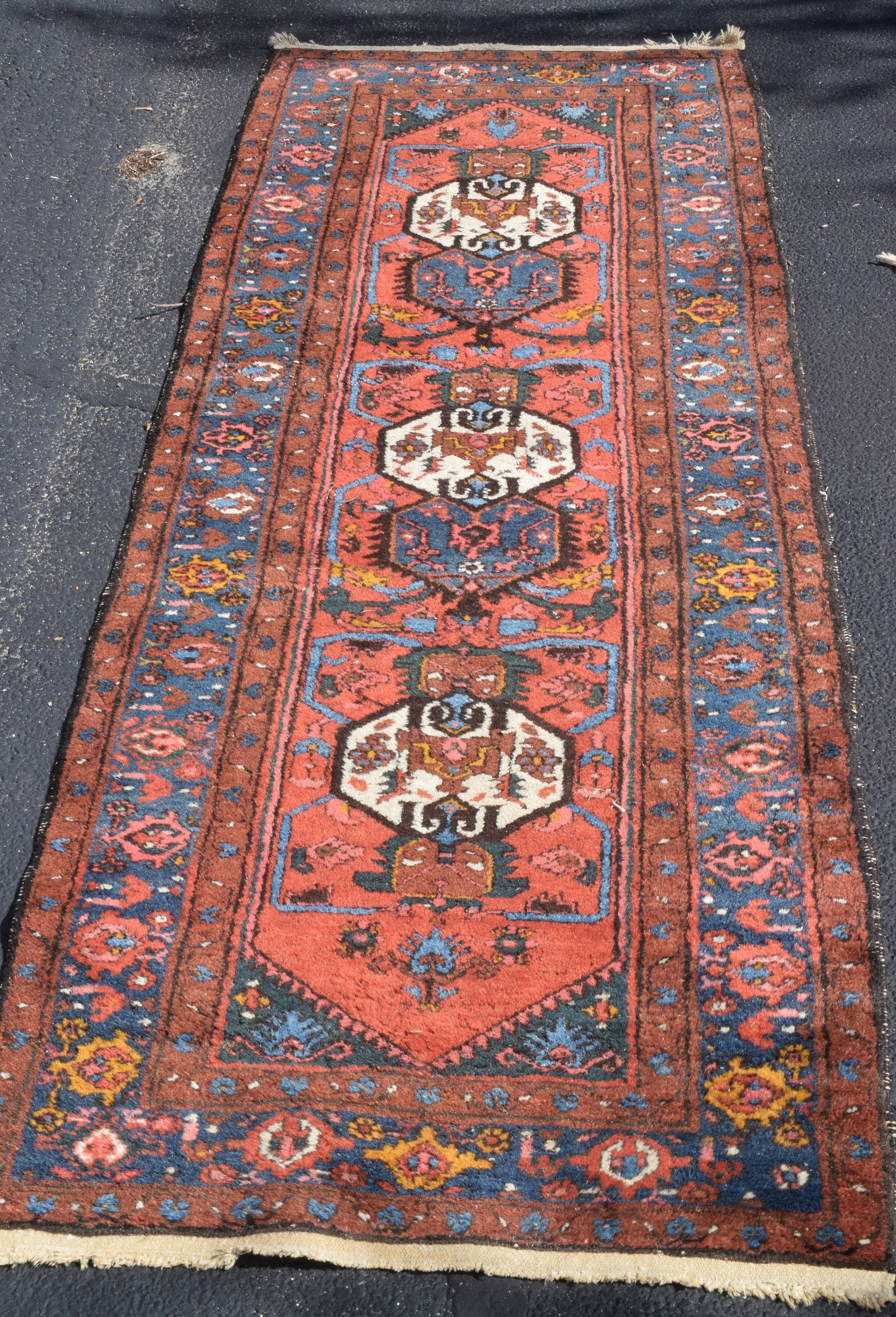 ORIENTAL WOOL RUNNER RUG: Likely Northwest Persian region, possibly from the Karadagh area. Geometric motifs and rich color palette of deep blues, burnt oranges, and earthy browns. Ca 1900-1930. Some moth damage and