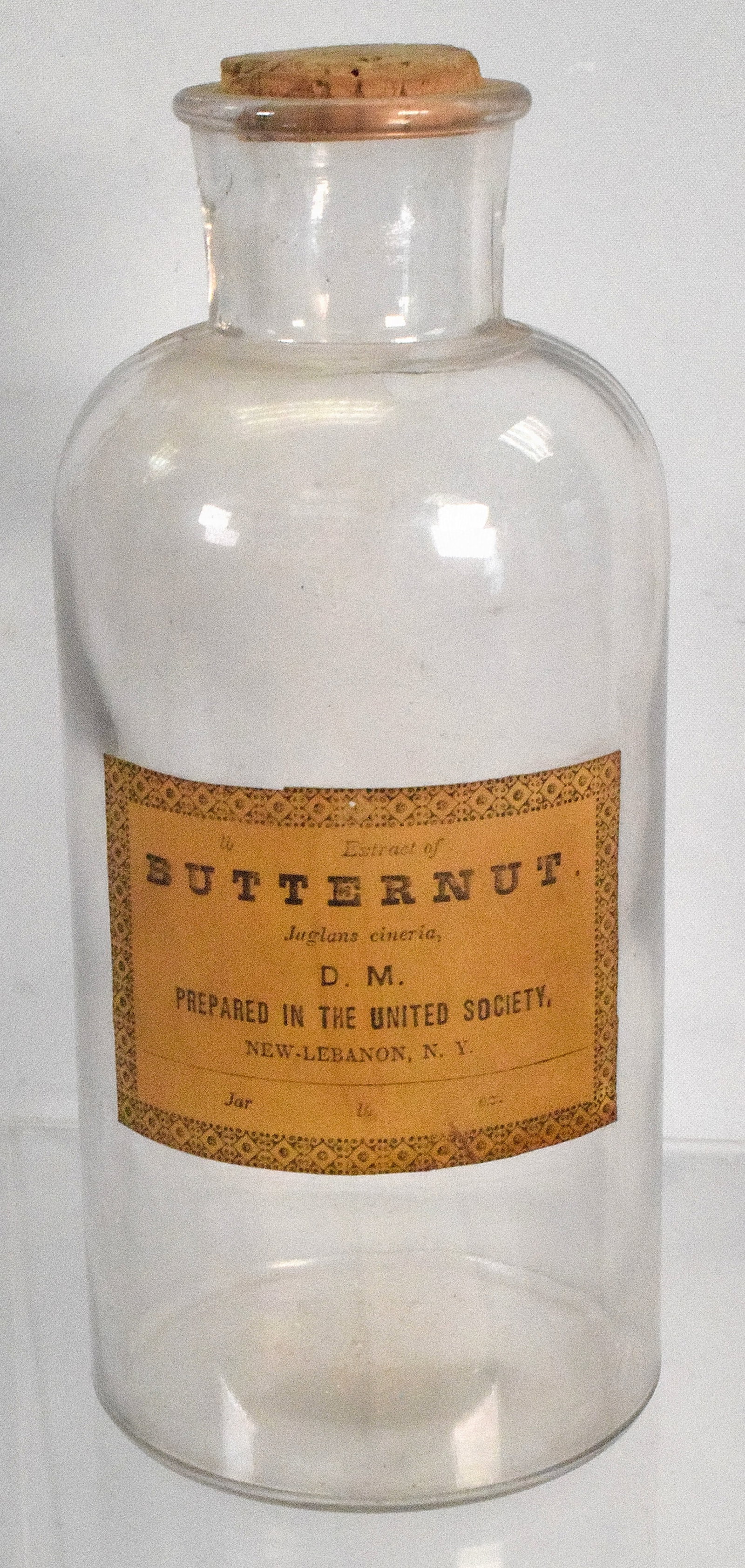 SHAKER BUTTERNUT JAR: Shaker butternut glass jar, good condition, has original label on front, the jar measures 10 1/2 " x 6 1/2 ".