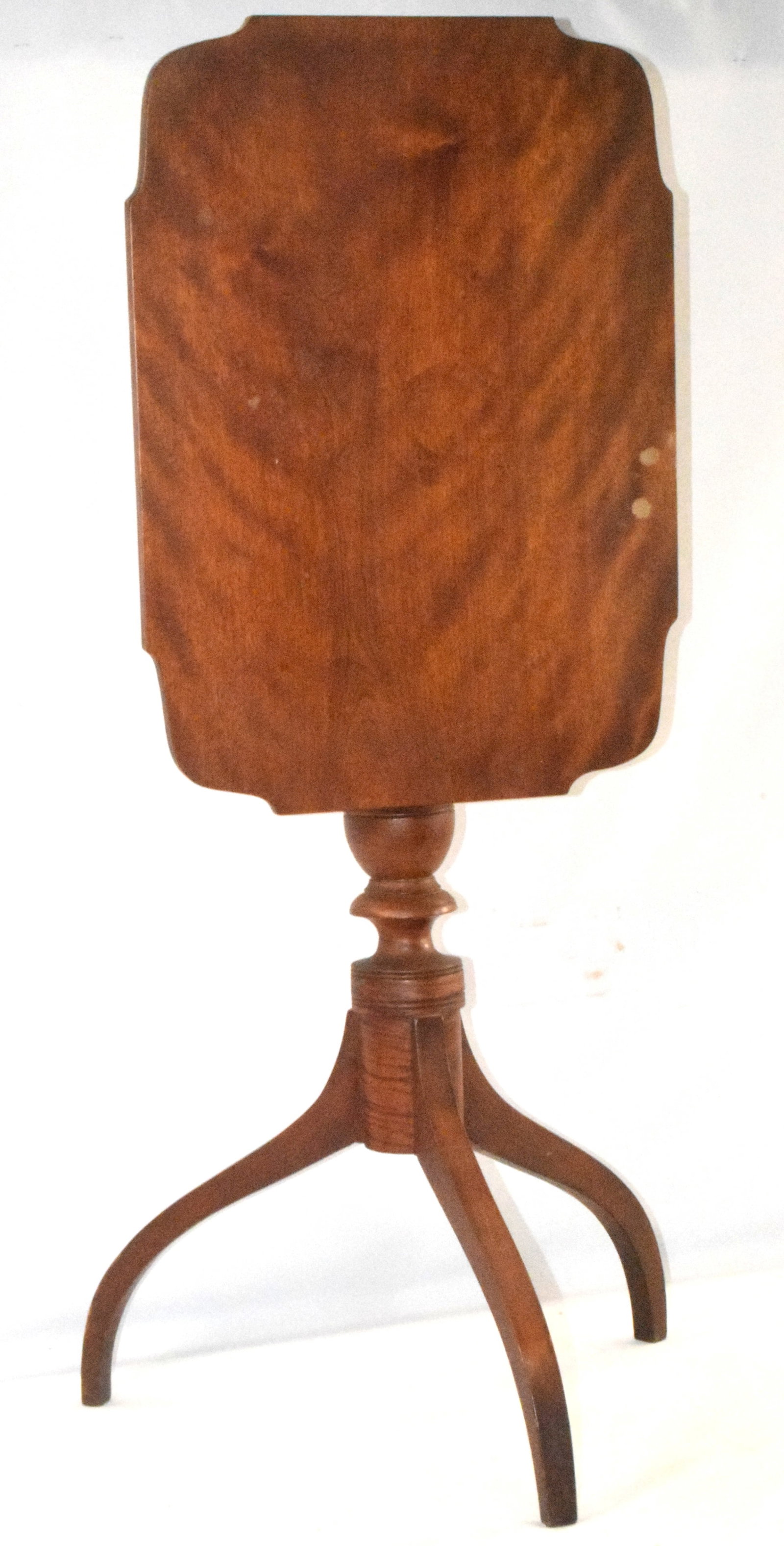 AMERICAN MAPLE TILT TOP CANDLESTAND: American period federal style tiger maple candlestand. 18th/19th century. New England. Shape top. 21 1/2 inches x 15 1/2 inches. Some spotting on top. Finish seems like a looks original.Turned