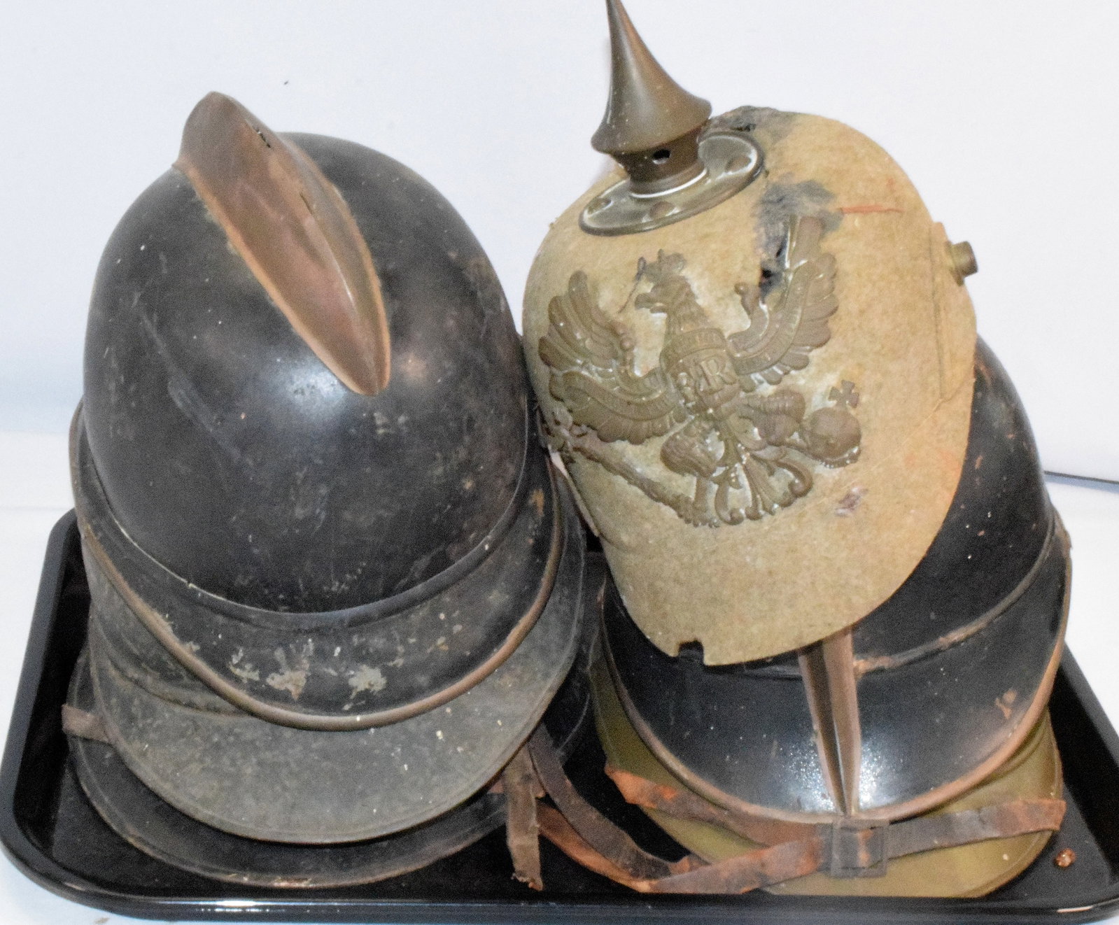 ASSORTED MILITARY FRENCH, & GERMAN HELMETS: 6 Assorted 19th and 20th military helmets. As is. Consists of 6 pieces. 1) WWI German Prussian felt helmet.. Does have condition issues. Split across the top and some loss to visor. Lining