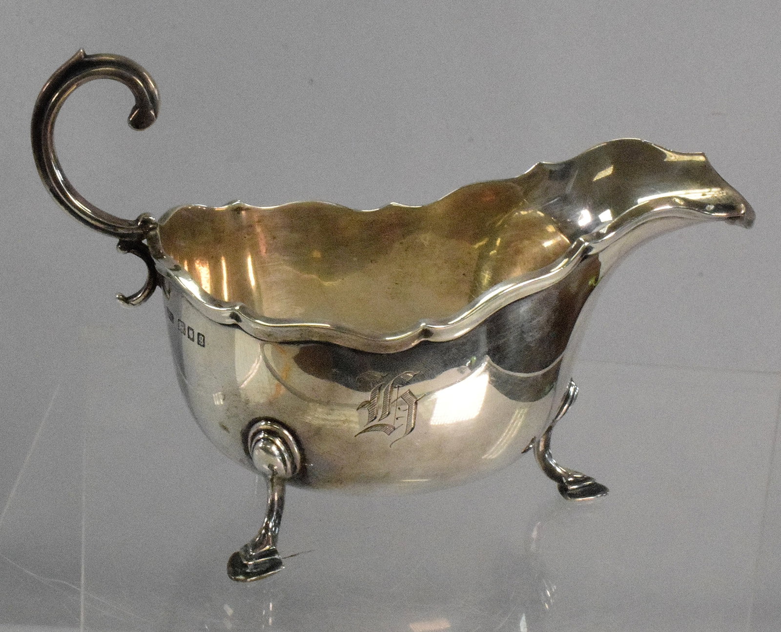 SILVER ENGLISH SAUCEBOAT: 6.62 troy ounces. Has a side hallmark from Crichton Brothers, also says on base "Crichton Made In England". The Crichton Brothers were silversmiths and antique dealers from 1890 to1954. Has hoof foote