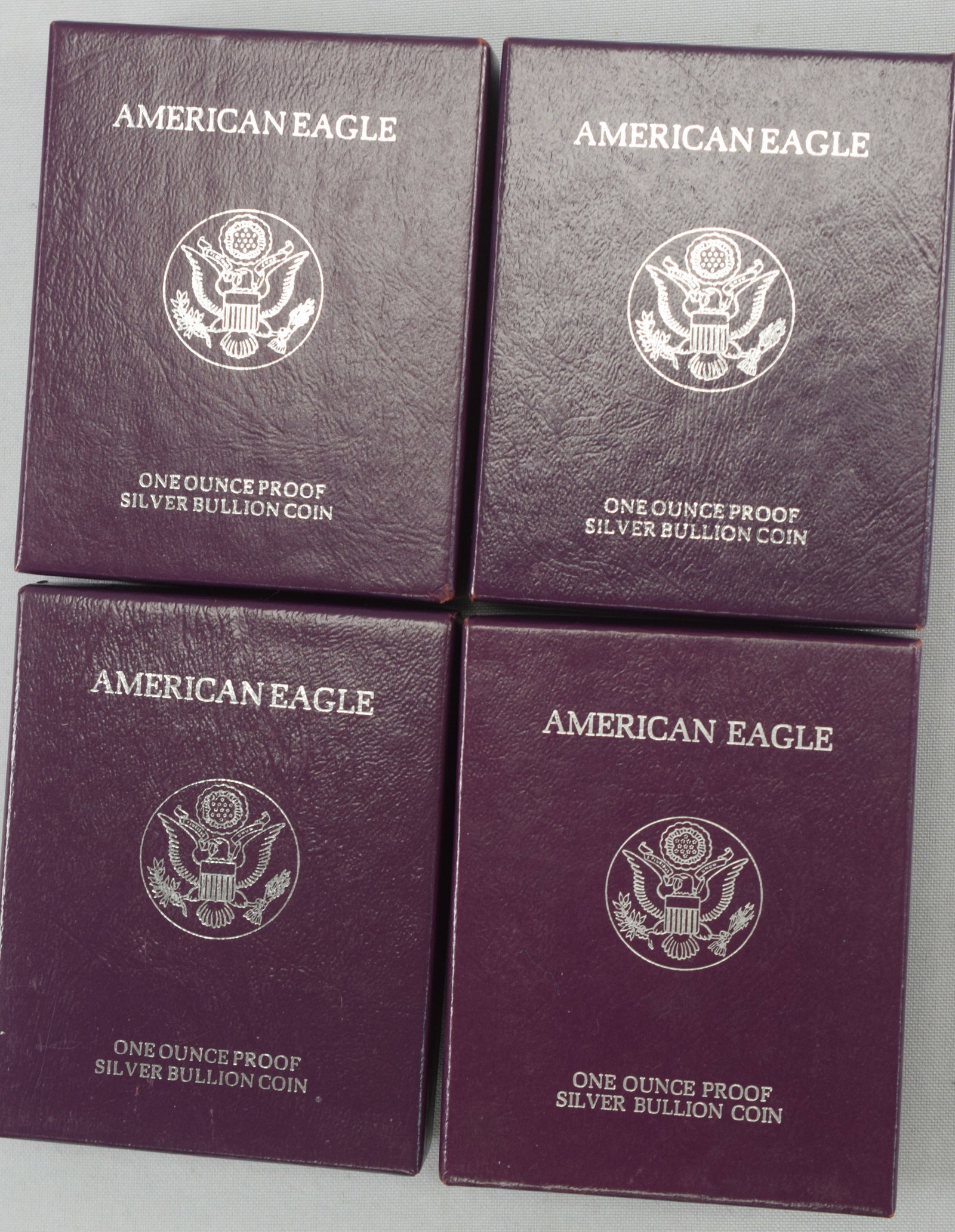 4 US AMERICAN SILVER EAGLE FINE SILVER COINS: 4 US American silver eagle fine silver coins, all 4 silver eagle coins are 1 ounce of pure silver, two are dated from 1990, one dated 1987 and the other is dated 1992, all measure 3 1/2 " x 4 1/2 "