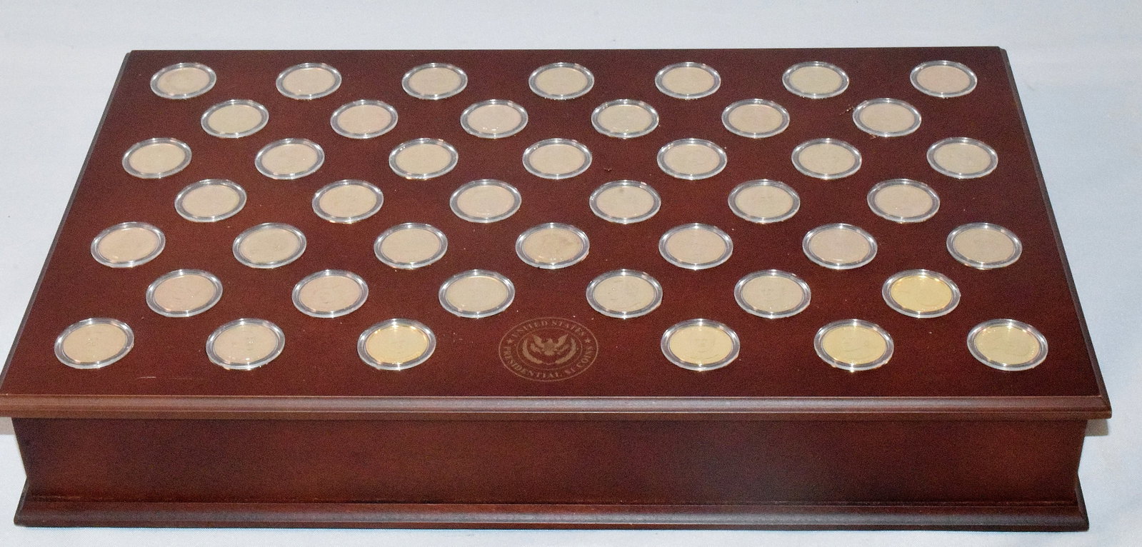 475 U.S. PRESIDENTIAL GOLD PLATED COINS: 475 U.S. presidential gold plated coins, good condition, Missing 20 coins out of collections, different president on each gold plated coins, measures 18 " x 4 1/2 " and weighs 7 pounds.