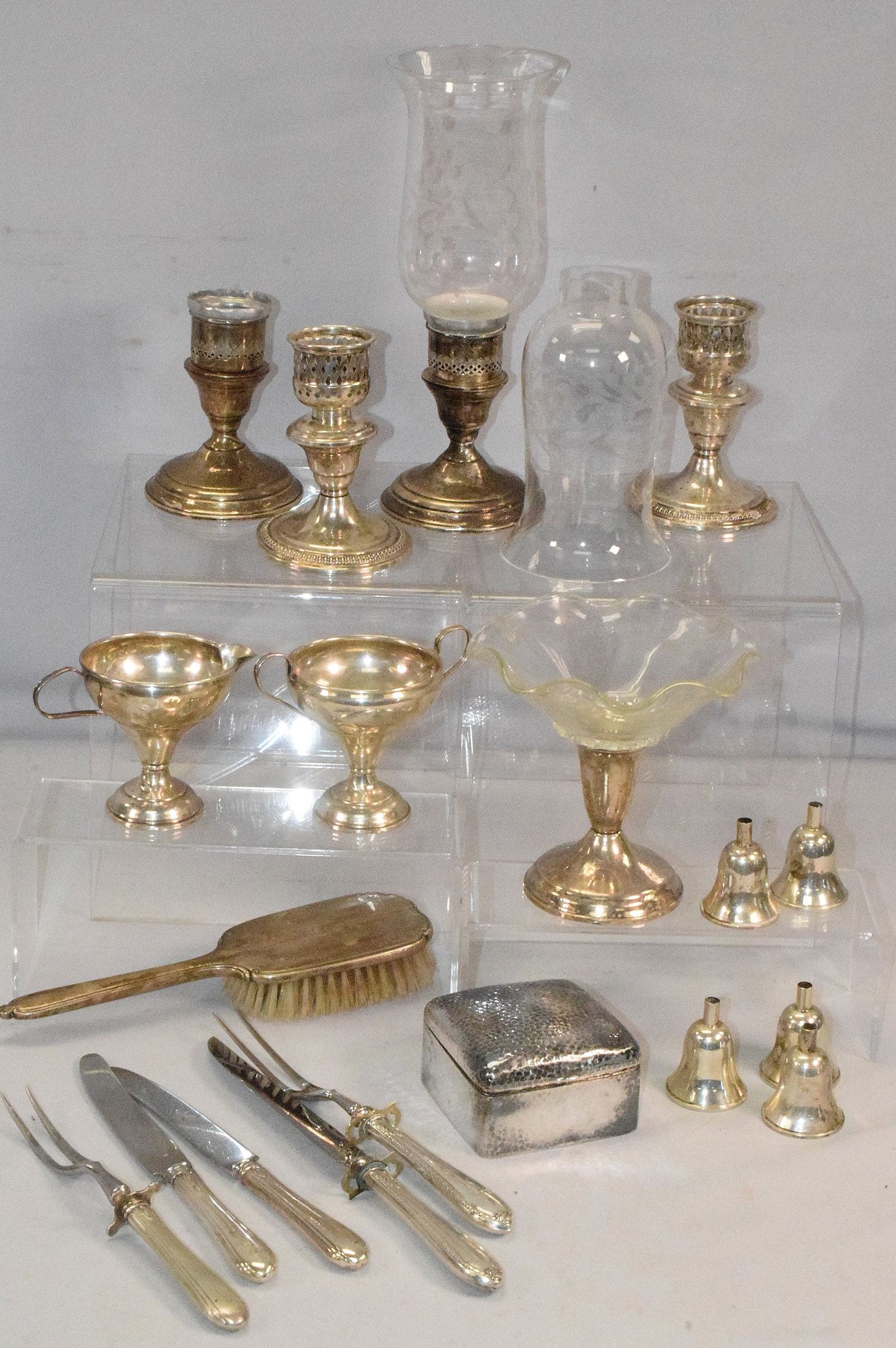 ASSORTED WEIGHED STERLING SILVER ITEMS: 18 Assorted weighed sterling silver items, contains carving set pieces, candlesticks, a brush, and etc. Also a Asian silver or silver plate box. Has Asian hallmark. As is 193 grams.Has dents. Some of