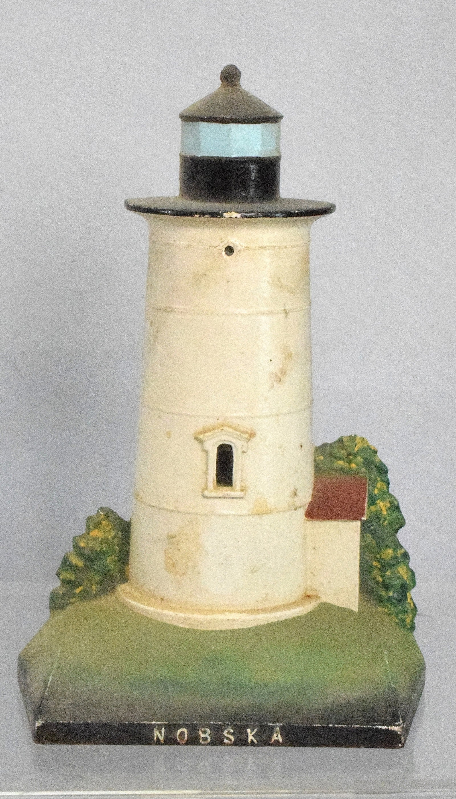 NOBSKA LIGHTHOUSE CAST IRON DOORSTOP: Ca 1991 Nobska Lighthouse Woods Hole mass cast iron lighthouse doorstop. Signed and dated on back. 9 inches tall. weight 6 pounds. Good condition.