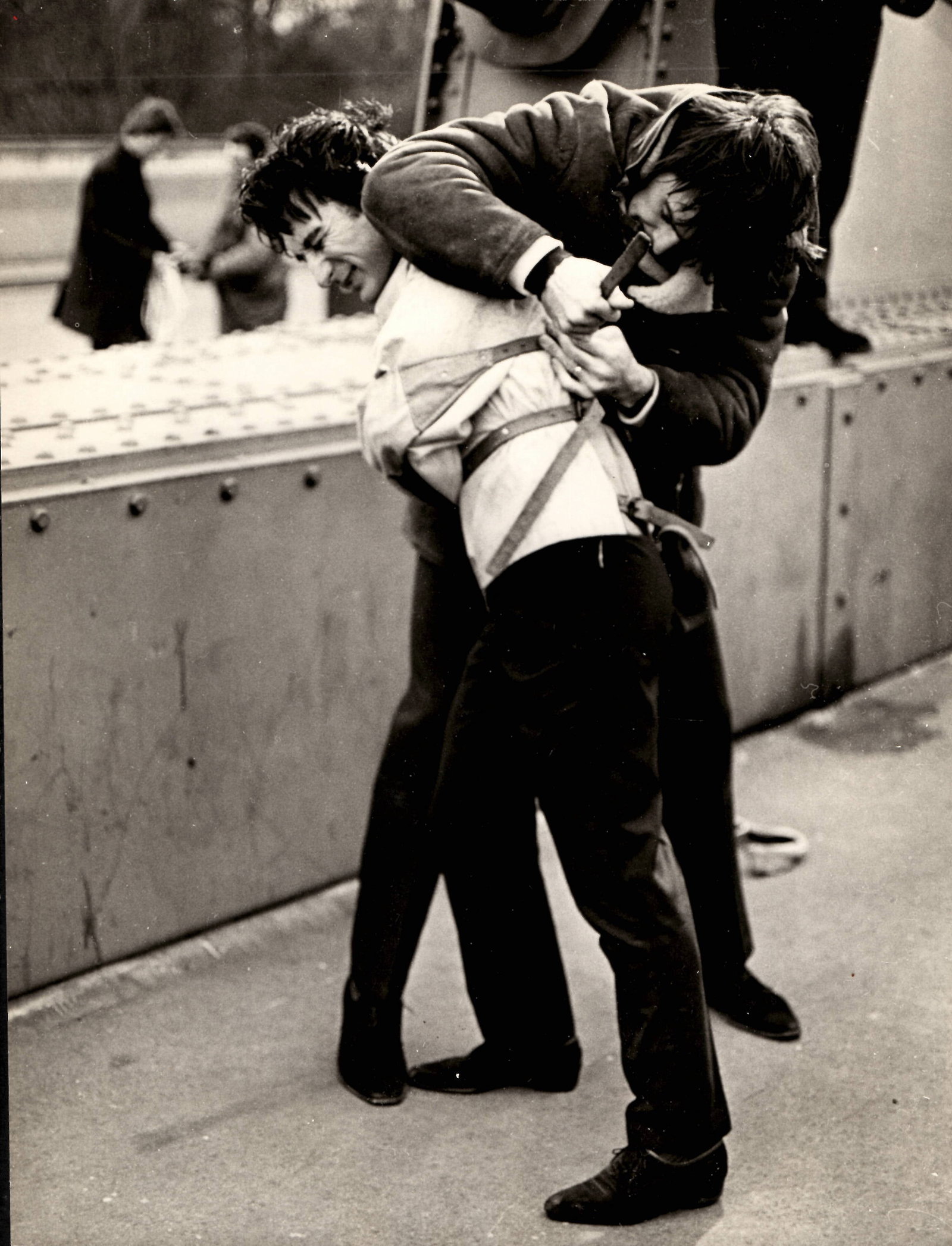 1967 Photo Magician Timothy Dill-Russell in Houdini Scape: This is an original photo. Twenty-nine-year-old magician Timothy Dill-Russell winces as his strait jacket is strapped up at the back prior to his spectacular escape while hanging head-down over the Th