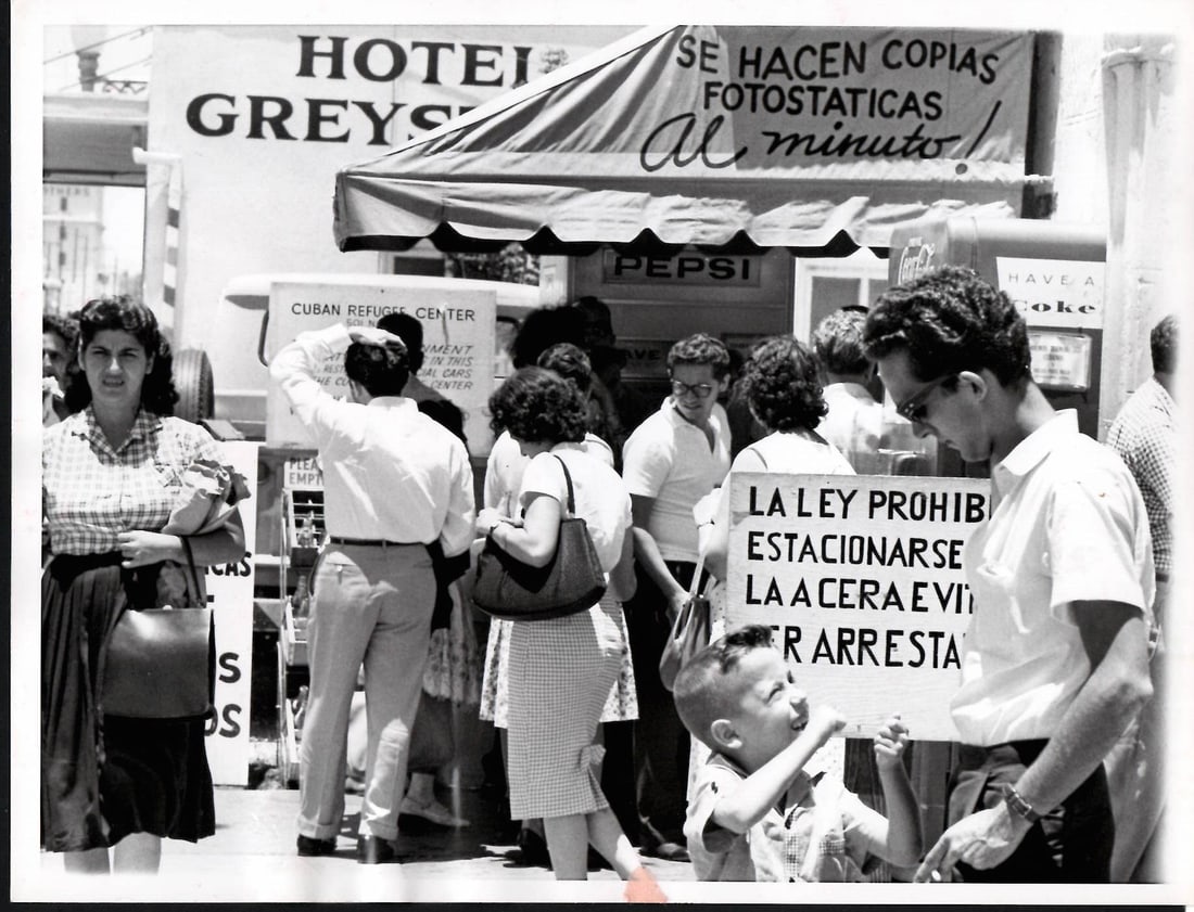 1962 Original Vintage Photography Cuban Refugees: 1962 Original Vintage Photography Cuban refugees gather in groups visiting the refugee centerThis is an original press photo. Spanish language signs mark the section of Miami, Fla., in which the thous