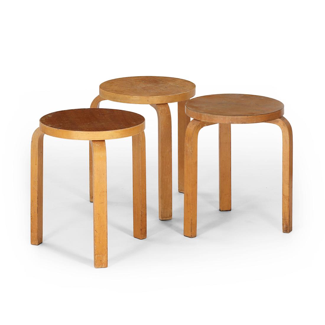 Alvar Aalto: A set of three circa 1930s to 1950s Aalto three-legged stools. Hard wood tops and patinated birch. Throughout the decades Aalto's chair and stool topsÂ have beenÂ available in an assortment of col