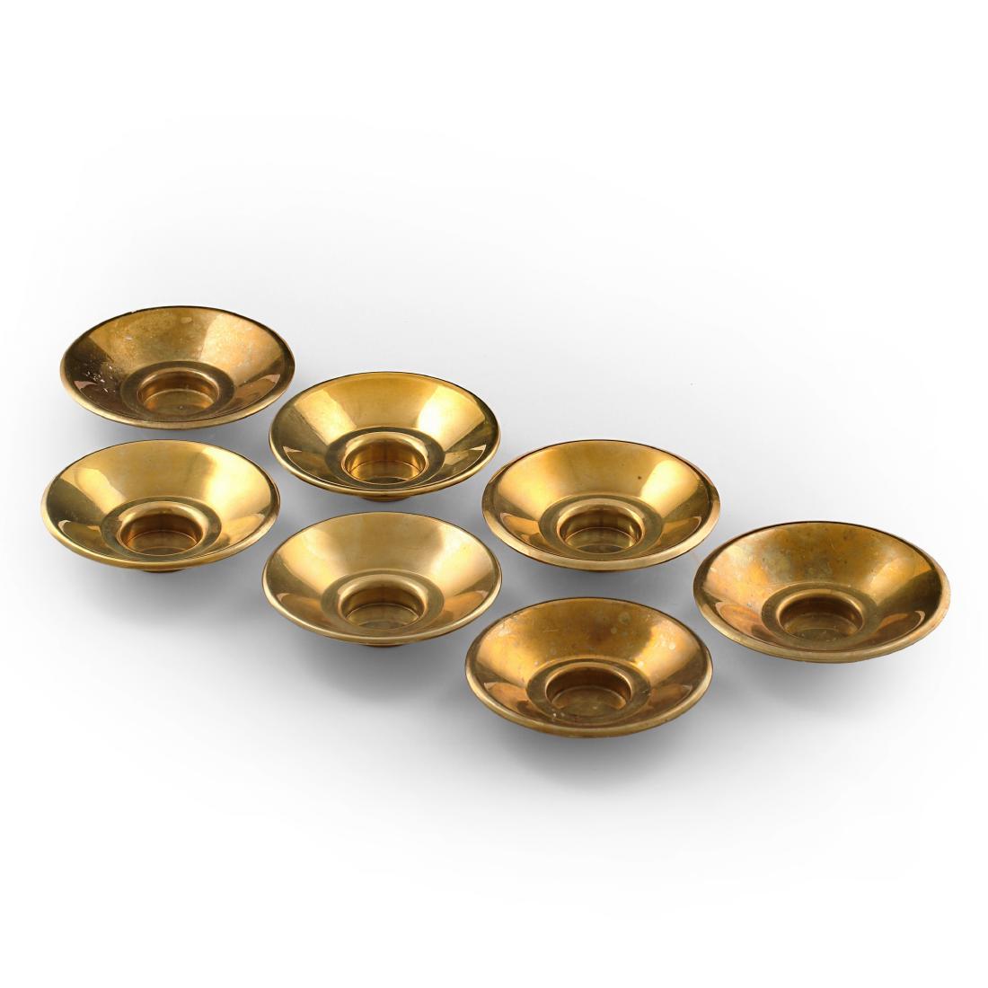 Maija Heikinheimo: A set of seven small brass candleholders by Maija HeikinheimoÂ manufactured by ValaistustyÃ¶ Ky. Stamped with the producer's markings. 1950s.