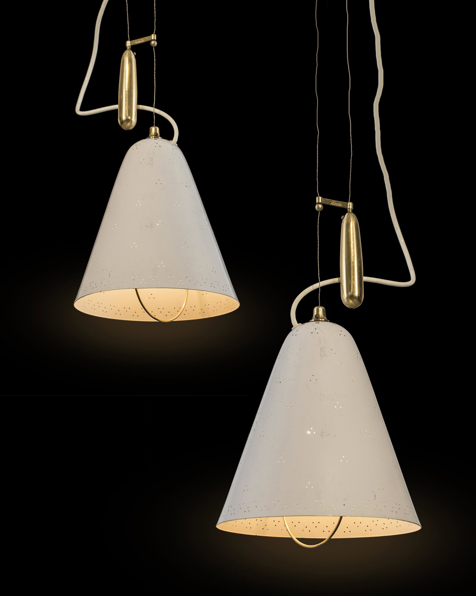 Paavo Tynell: A pair of "A1942" adjustable pendant lights designed by Paavo Tynell for Idman, signed "Idman". Brass, painted metal. Shade height 38cm, shade diam. 26cm