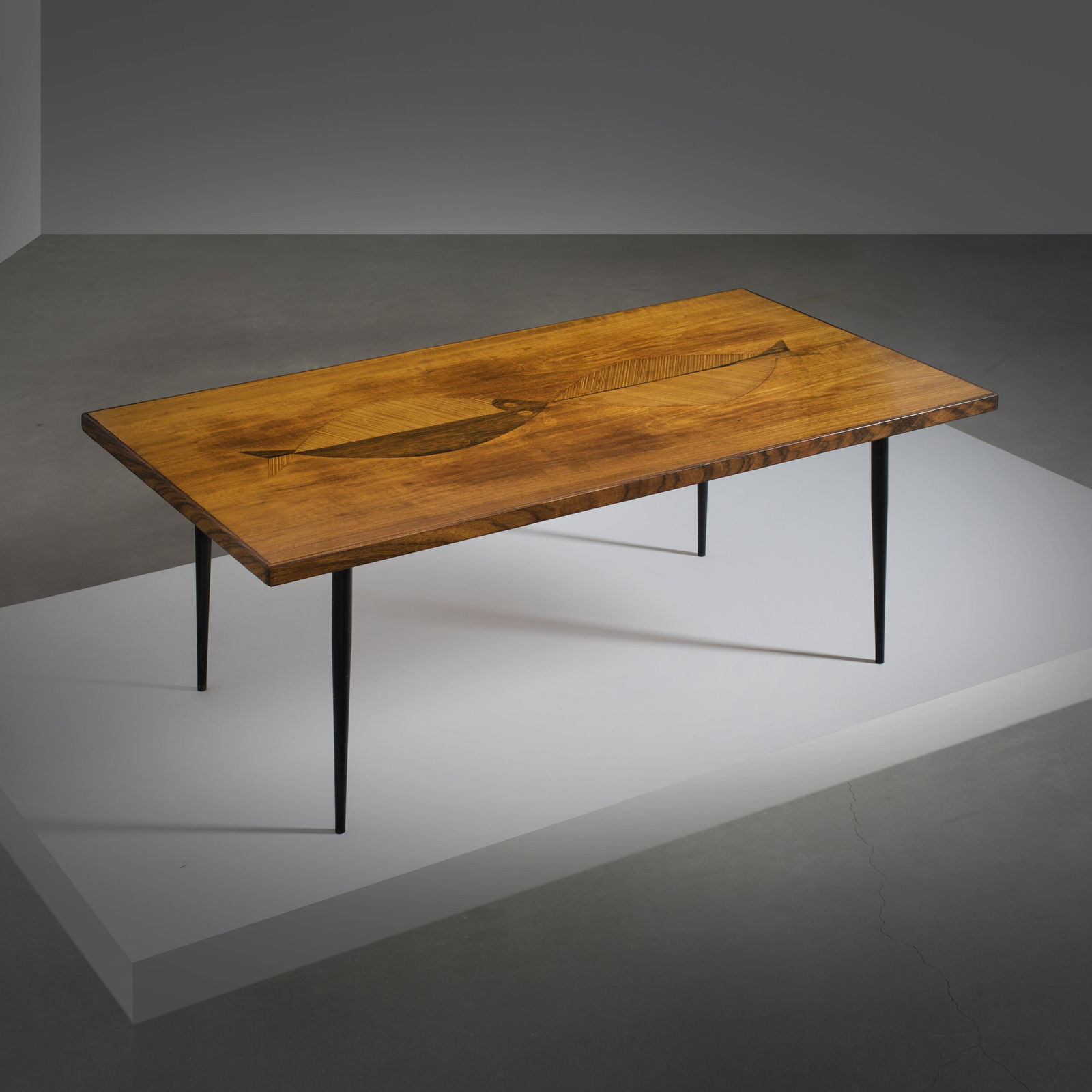 Tapio Wirkkala: A mahogany veneer coffee table with fish intarsia patterns, designed by Tapio Wirkkala for Asko.. Height: 43cm, table top: 116x62cm. Signed -