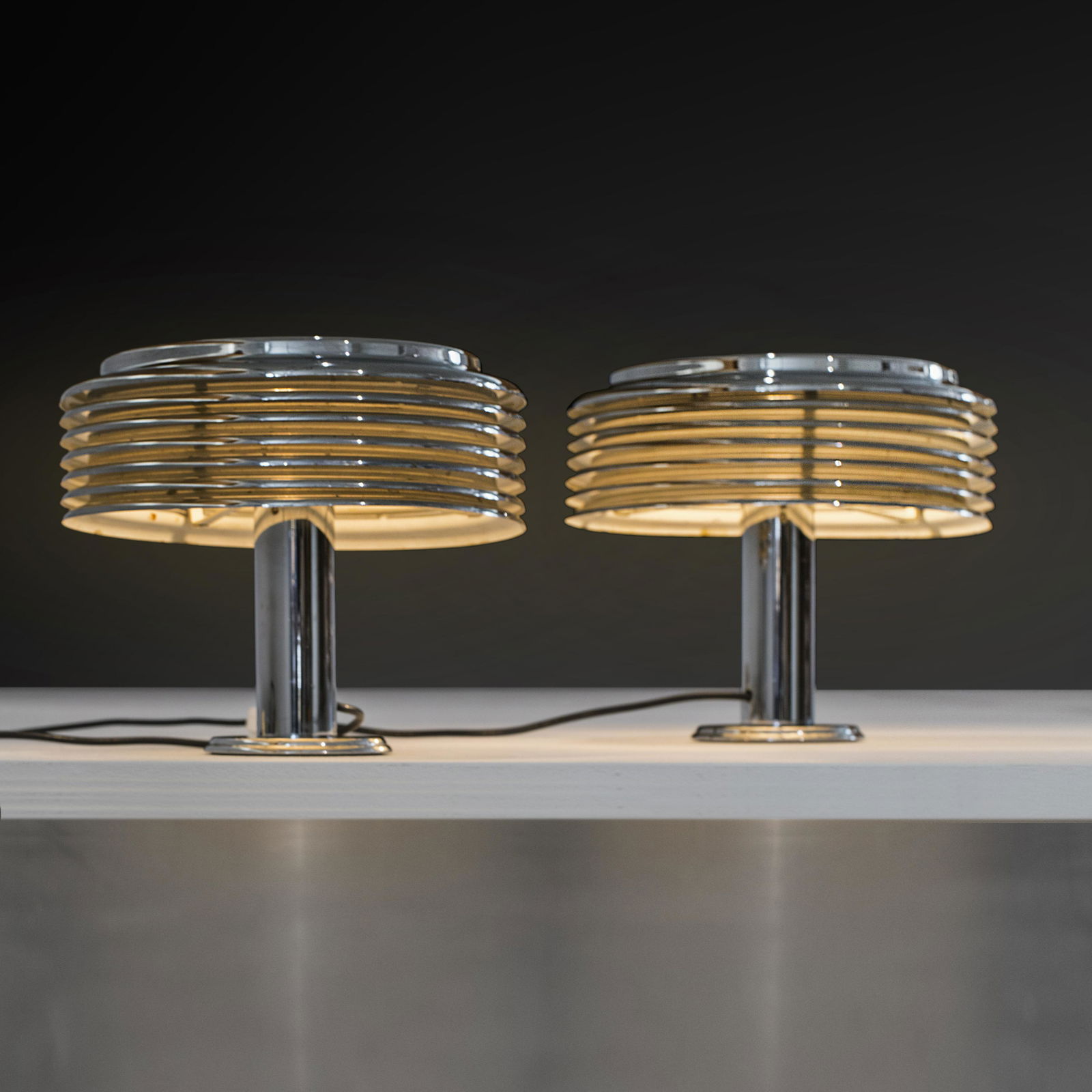 Kazuo Motozawa: A pair of chromed ”Saturno” table lamps designed by Kazuo Motozawa in the 70's, Medium = Metal, Height= 30cm, diameter= 33cm,