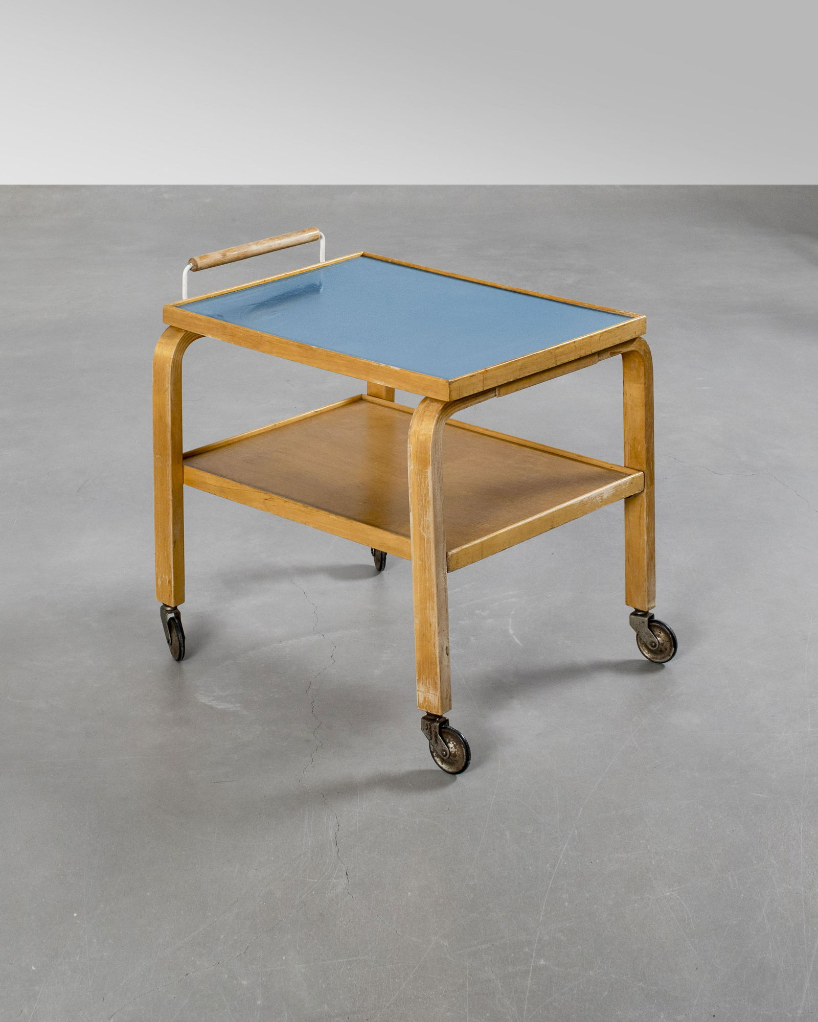 Alvar Aalto: A tea trolley with blue linoleum top and an intermediary shelf, designed by Alvar Aalto, Medium = Wood, linoleum, Height= 57cm, X
