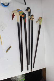 Lot of 5 Different Multi-Type Canes: This is a lot of 6 wood canes. The swan cane the has a redial with a white head and 2 brown glass eyes. Swan head fades from white to black forming the cane. Measures 36". The Peter Rabbit Cane is a t