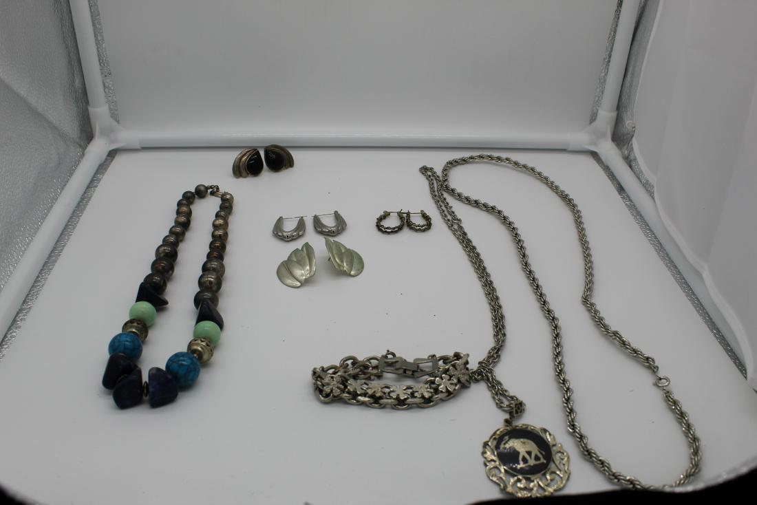 Lot of 8 piece costume jewelry: This is a a lot of different pieces of costume jewelry. Varying from chains (14 in. &14 1/2 in.), bracelets ( 3 1/2 in.) and 4 different pairs of earrings (1 in., 1 1/4 in., 1 in., 1 in.). One of the 