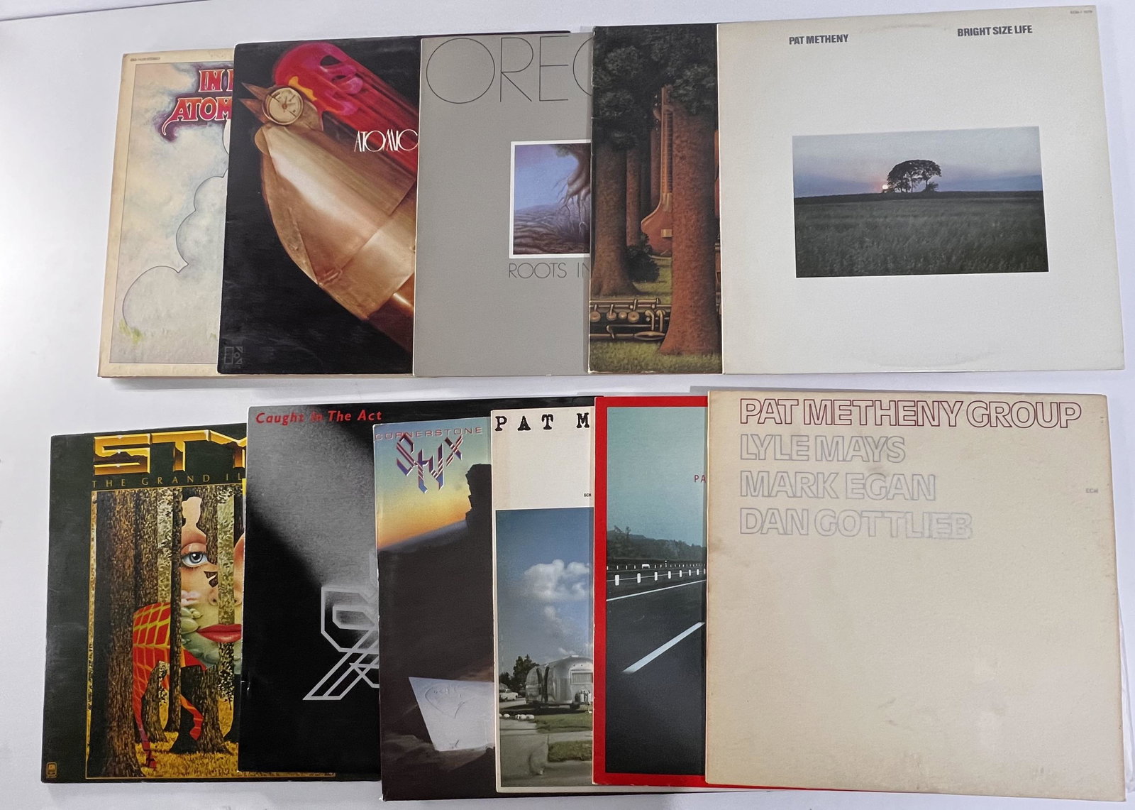 STYX, Pat Methany, Oregon , Atomic Rooster Vinyl Albums - Lot of 11: The Grand Illusion - Styx 1977: Side 1: Serial No. R130453A Side 2: Serial No. R130453B, Caught in the Act - Styx - 2 Disc Album - 1984: Disc 1- Side 1: Serial No. SP-06514A-1D Side 2: Serial No. SP-0