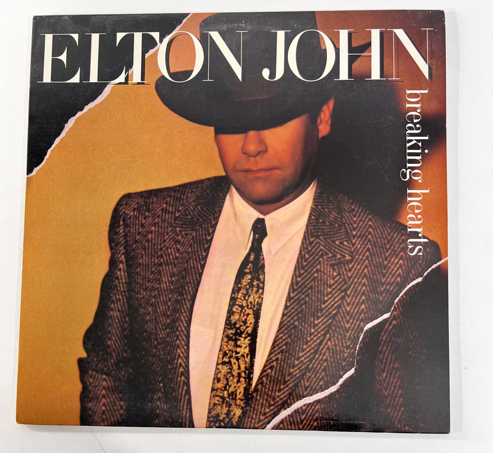 1984 Elton John "Breaking Hearts" Vinyl Album: 1984 Elton John "Breaking Hearts" Vinyl Album. It measures 12" We looked at this vinyl and it is in good used condition. Side 1 Serial No. 24031-A Side 2 Serial No. 24031-B.