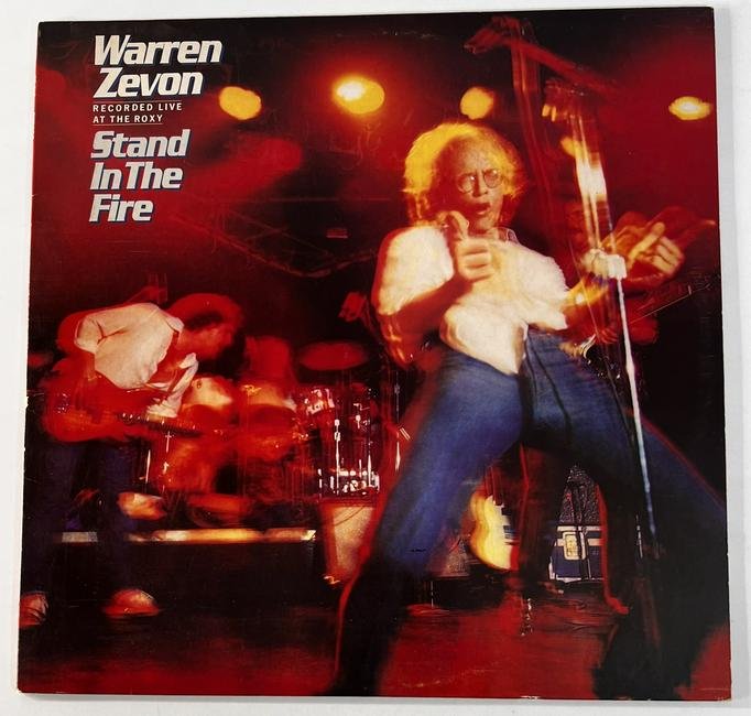 1980 Warren Zevon "Stand in the Fire" Recorded Live at the Roxy Vinyl Album: 1980 Warren Zevon "Stand in the Fire" Recorded Live at the Roxy Vinyl Album. It measures 12". We looked at this vinyl and it is in excellent used condition. Side 1 Serial No. 5E-519-A Side 2 Serial No