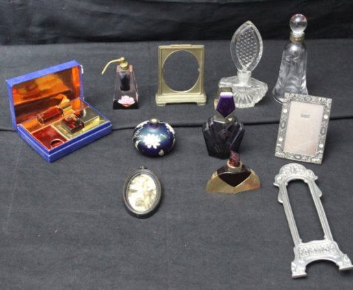 Lot of Vintage Picture Frames and Perfume Bottles: Lot of Vintage Picture Frames and Perfume Bottles. There are 4 different pictures frames. 1 Oval shapped, that has a picture of a man in a suit holding the hand of a little child. There's writing on t