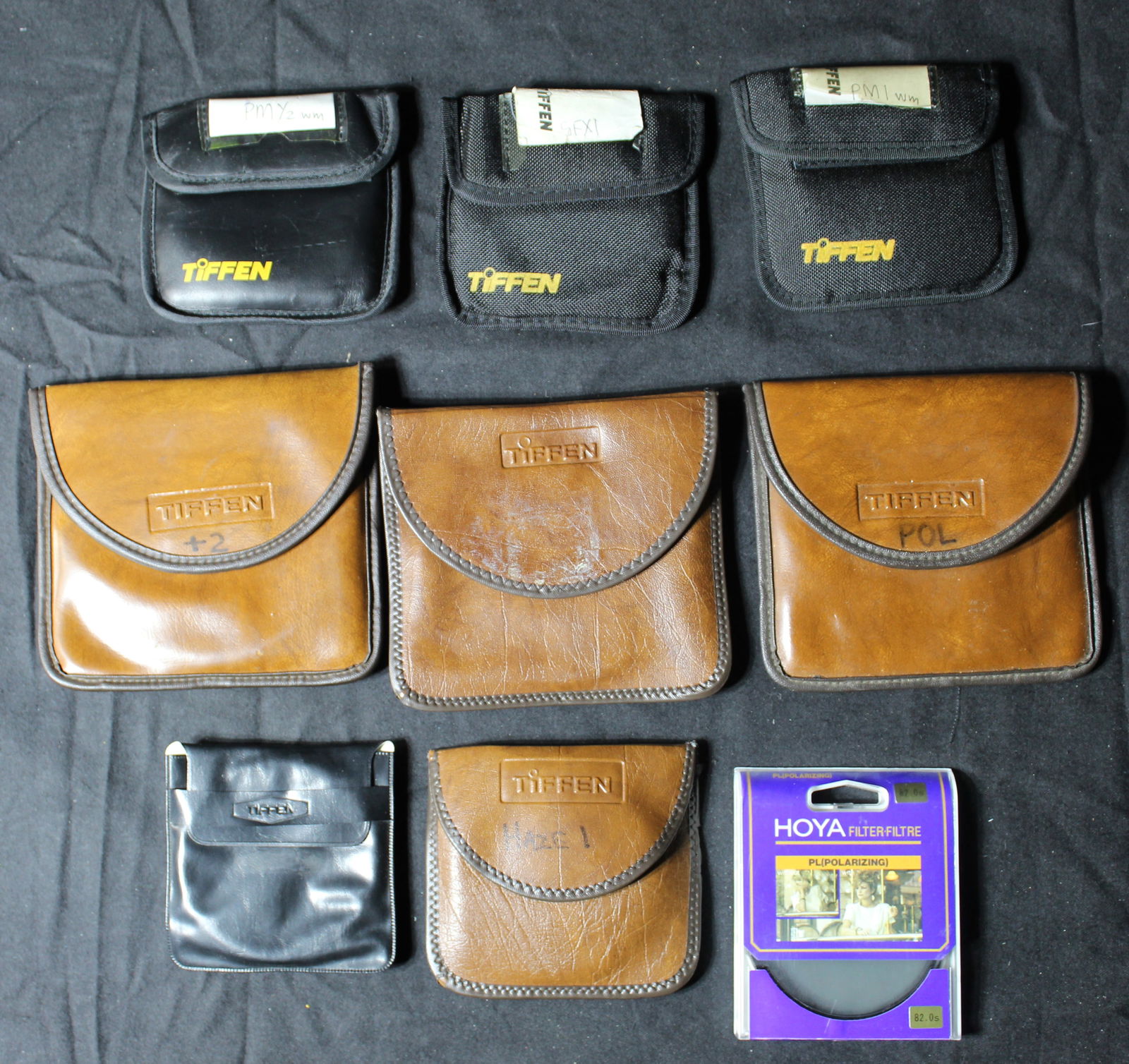 Lot of 9 Tiffen Polarized, Photar, Professional Lens, Hoya Filter, Harrison Texture Screen Lenses: (1) Tiffen 4 1/2” Polarized USA, (2) Tiffen Professional Ser. 9 UV Haze-1 U.S.A, (3) Tiffen Photar Plus 1 Series 9 U.S.A, (4) Tiffen Professional 4 /12” Plus +2 U.S.A - has a few minor sig