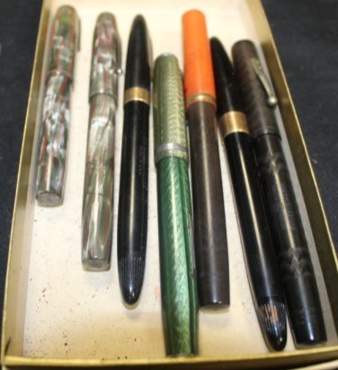 Lot 7 of Fountain Pens 4 14K Gold Nips 3 Reg Nips: Lot of 7 Fountain Pens 4 14K Gold Nips 3 Reg Nips. 3 Waterman 14K Gold Nips. Each has Waterman Ideal 14k written on the Nips. 2 have a multicolor design, and 1 is a brown and orange color. 1 14k Gold 