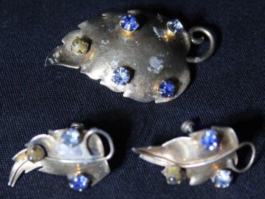 Sterling Silver Earrings and Brooch Set 14 grams: This Sterling Silver Earrings and Brooch Set are shaped as leaves, the brooch have 5 different jewels afixed to the front and the earrings have 3, he brooch measures 2" x 1" and the earrings measure 1