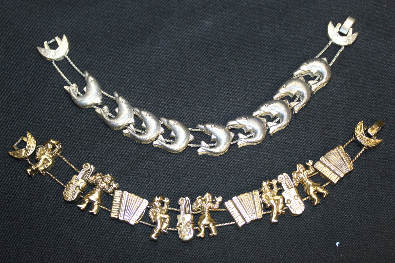 (2) TOFA Physician Slider Gold & Silver tone Charm Bracelets - Line Dancing & Dolphin Charms: (2) TOFA Physician Slider Charm Bracelets - Line Dancing & Dolphin Charms. This is a beautiful lot of jewelry that will be perfect for any special occasion. They're all various sizes. styles and color