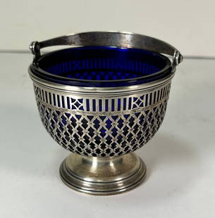 Tiffany & Co. Sterling Silver Sugar Basket w/ Cobalt Blue Glaass Insert: Tiffany & Co. Sterling Silver Sugar Basket w/ Cobalt Blue Glaass Insert. An elegant sterling silver basket with a cobalt blue glass insert. The handle of the basket is engraved with E.J.K, Tiffany & C