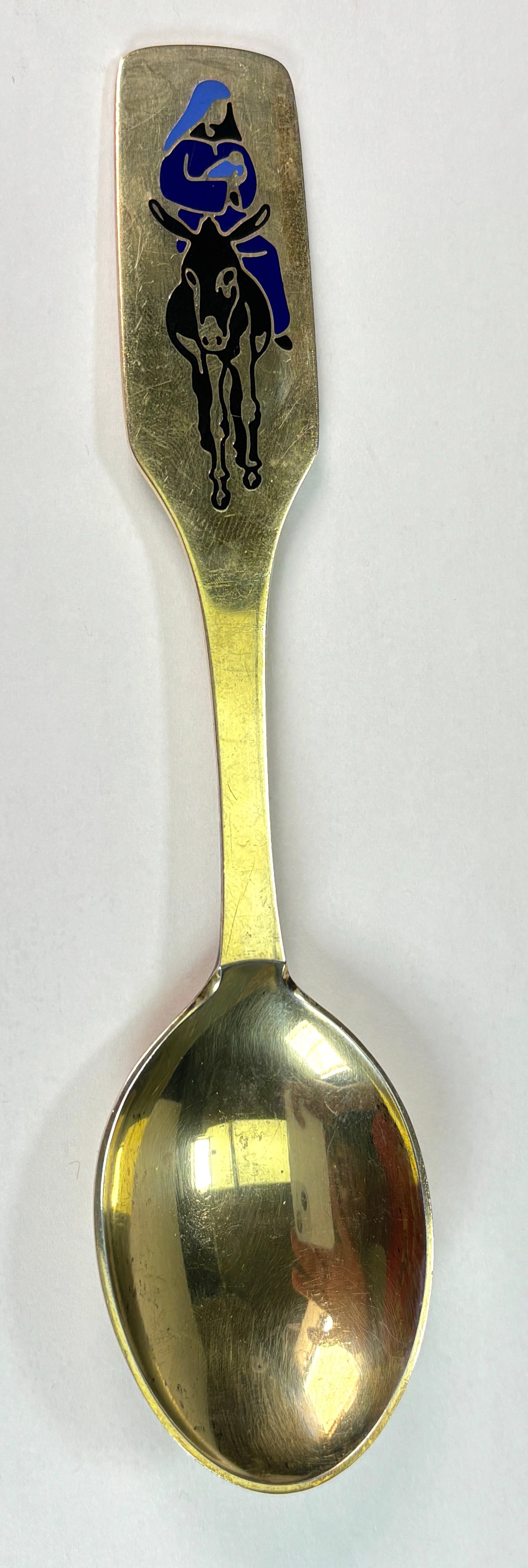 A. Michelsen Christmas Spoon: The Flight into Egypt - Jorgen Dahlerup - 1966 - 24kt GP over 925 SS: A. Michelsen Christmas Spoon - The Flight into Egypt - Jorgen Dahlerup - 1966. A beautiful 24kt Gold Plate over 925 Sterling silver spoon with Blue and Black enamel design of a person sitting on a don