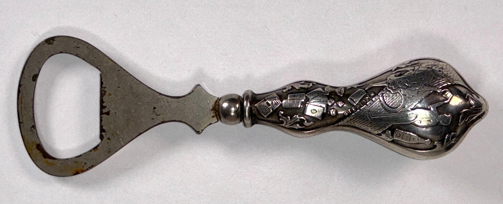 RARE Antique 1894 Sterling Silver Gambling Themed Bottle Opener: This RARE Antique Gambling Themed Bottle Opener was crafted in 1894, from sterling silver. It is unique and a testament to a bygone era of gaming and craftsmanship. The handle features an intricate ga