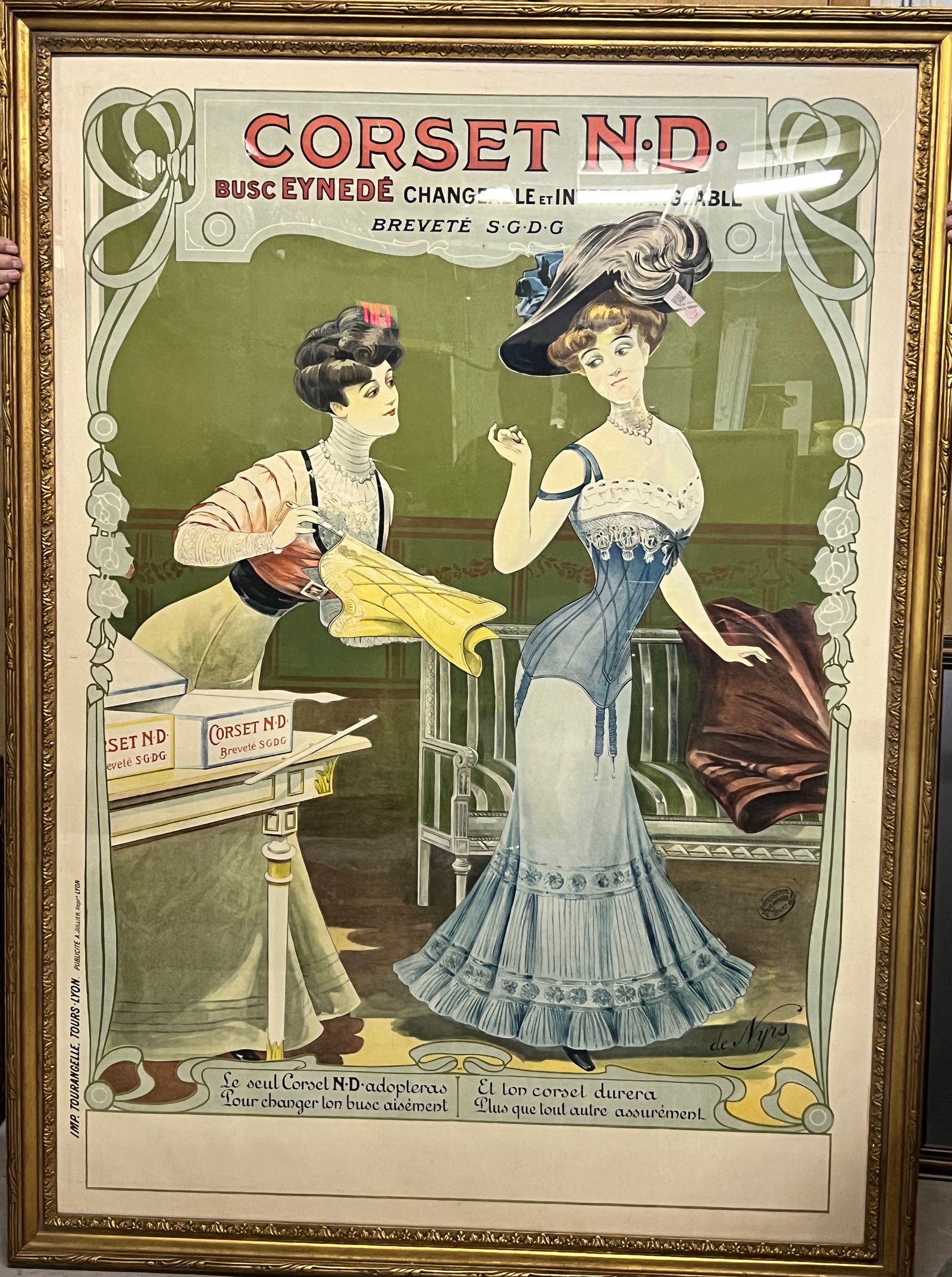 1905 Corset N.D Lithograph: This is a vintage advertisement poster for the "Corset N.D.". The lithograph, created in 1905 by an artist named de Nyrs, a French advertisement that highlights the ease of changing the corset's