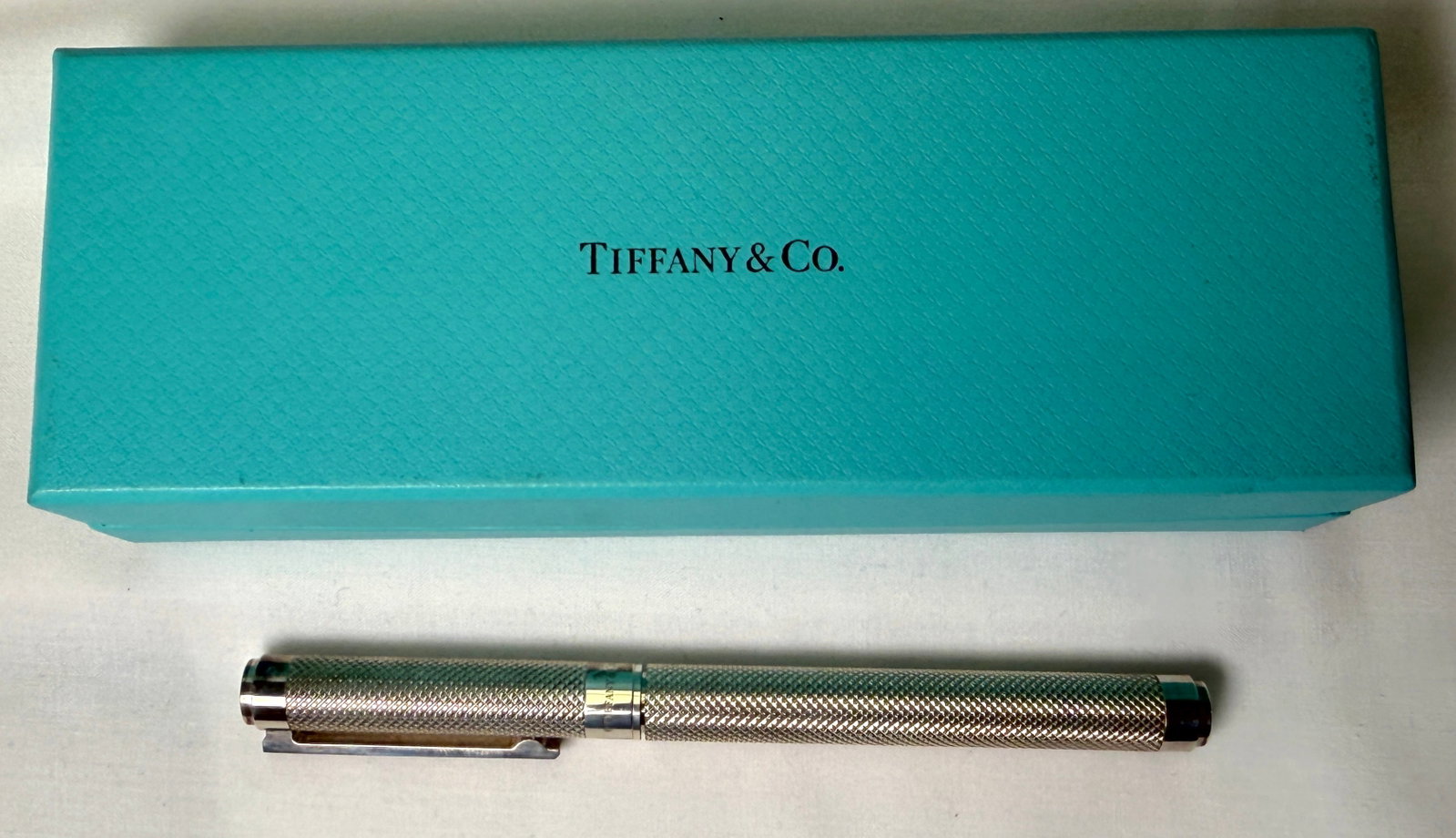 Tiffany and Co AG925 Germany Ballpoint Pen: Own a piece of iconic luxury with this Vintage Tiffany and Co, expertly crafted in Germany. hallmarked AG925. The Ballpoint Pen comes with the original case. It is a collectible item. a classic writin