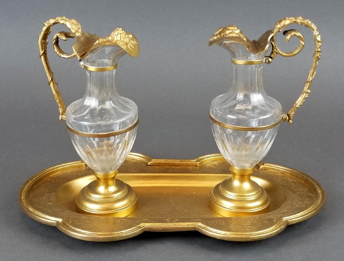 19th C. French Bronze & Crystal Cruet Set: 19th C. French Bronze & Crystal Cruet Set. The tray measures 10" x 6" and the bottles measure H: 6 1/2" W: 3 1/2"