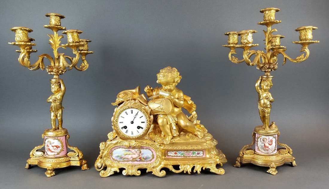 19th C. French Sevres & Figural Bronze Clockset: 19th C. French Sevres & Figural Bronze Clockset. The clock measures H: 12" W: 15 1/2" and the candelabras measure H: 18" W: 10 3/4"