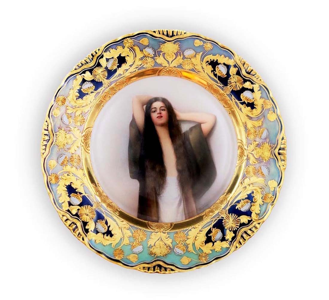 Signed 19th C. Royal Vienna Plate, Made In Germany: Hand painting of a French girl. Frame is designed with fine 24k gold leaf and fine enameling. Signed by ' Wanger ' on the lower right. Beehive underglaze Vienna marks. W 9 1/2". (Condition: Excellent)