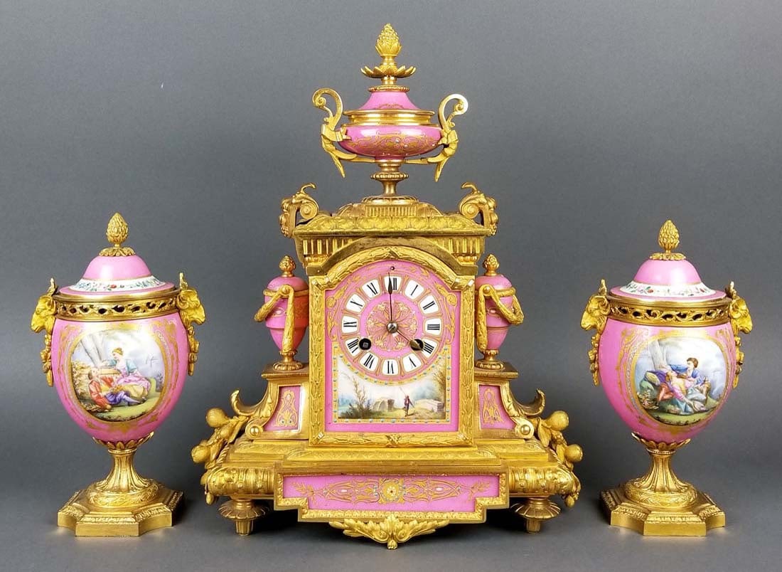 19th C. French Sevres Bronze and Porcelain Clockset: 19th C. French Sevres Bronze and Porcelain Clockset. The clock measures H: 14 3/4" W: 12" and the vases measure H: 9 1/4" W: 5"
