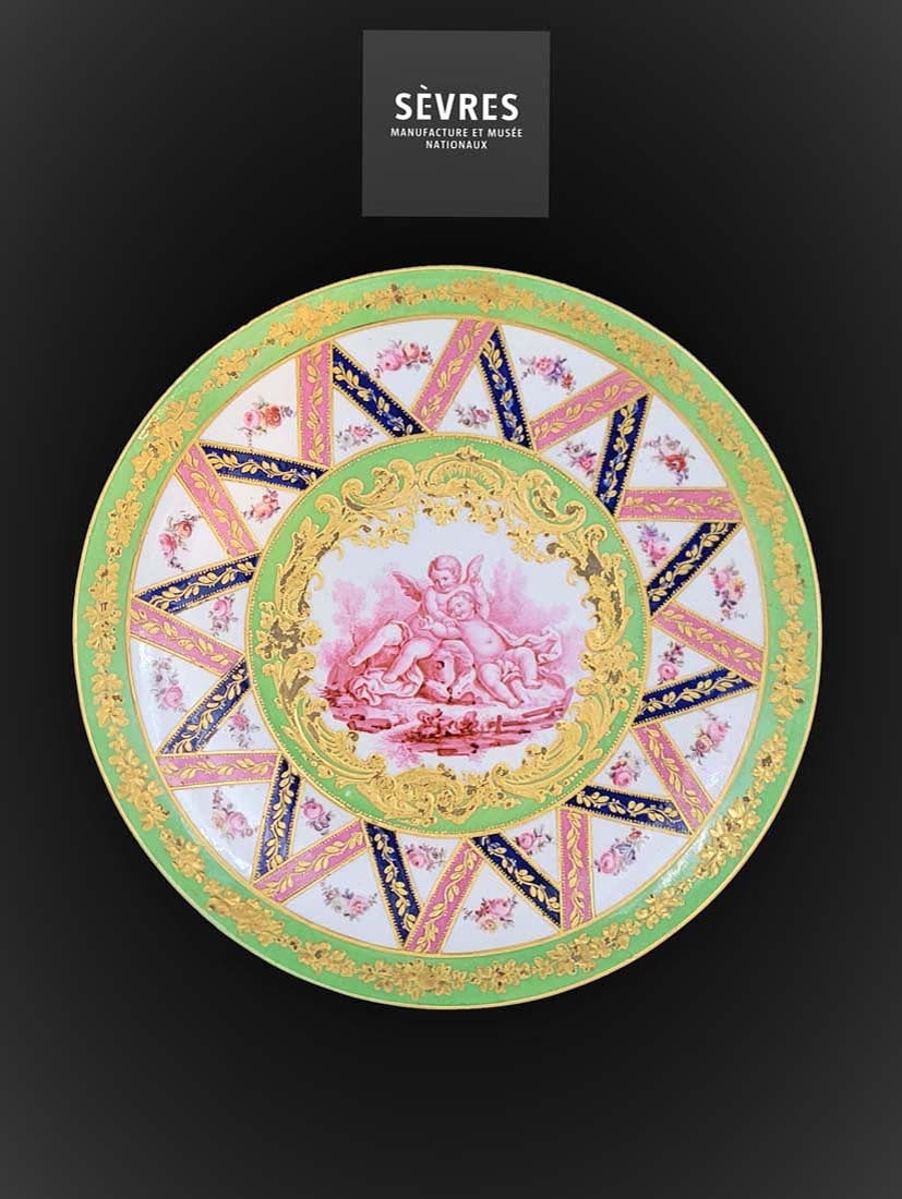Late 18th Century Hand Painted Sevres, Made In France Plate: Hand painted of 2 cupids in center. Plate is designed with fine enameling and flower paintings. W 9 ?? (Condition: very good)