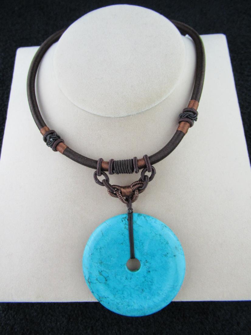Turquoise Harmony Pendant: Turquoise Harmony Pendant on Brown Cord with Braided Bail Accents, Dimensions: 2.5" (L) x 2.5" (W) x 0.2" (D), Weight: 57.2g